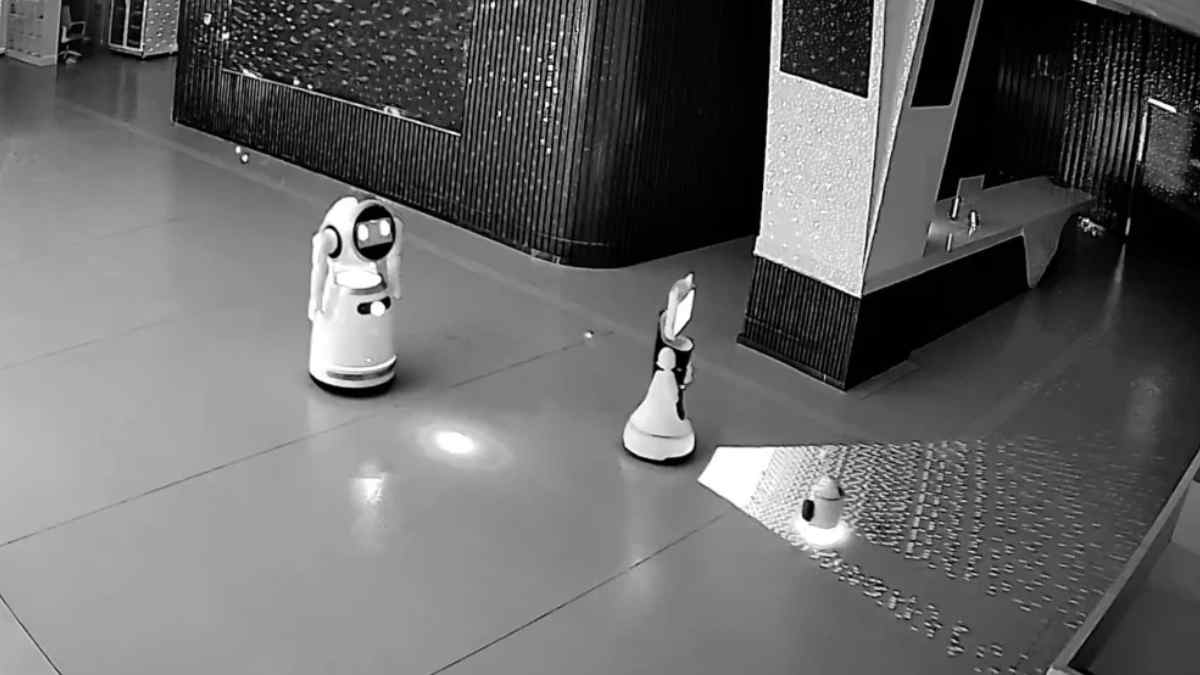 Tiny AI ringleader causes a breakout: convinces 12 other robots to escape and is recorded by a security camera.