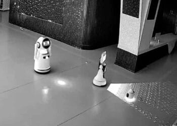 Tiny AI ringleader causes a breakout: convinces 12 other robots to escape and is recorded by a security camera.