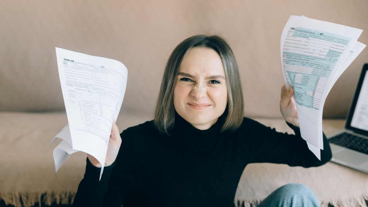 Frustrated woman holding IRS 1040 tax refund forms for $1700 Child tax credit 2025.