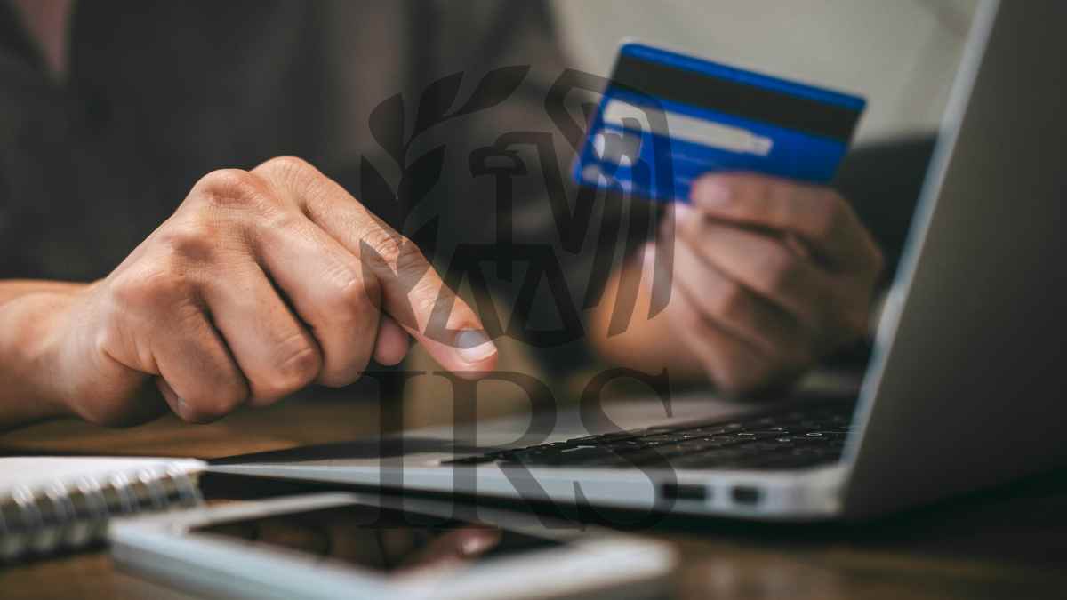 Person using a credit card on a laptop to make an online purchase