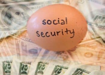 Egg labeled 'Social Security' on top of U.S. dollar bills, symbolizing retirement savings and pension benefits