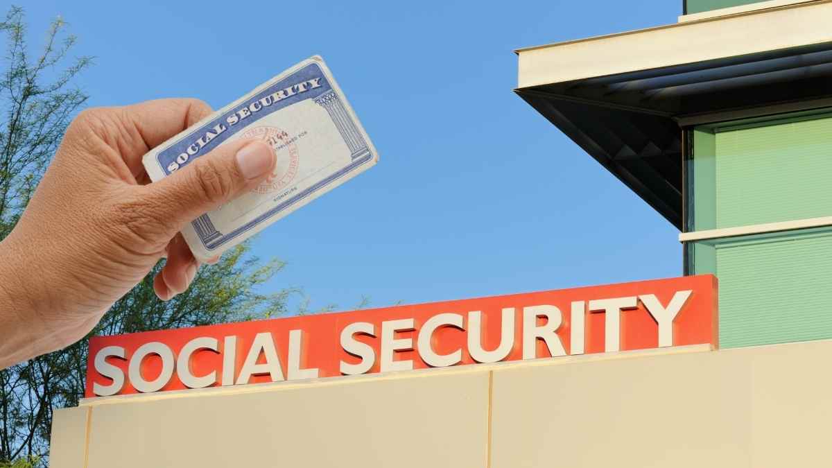 Social Security card in hand in front of the Social Security office, representing cuts in retirement benefits