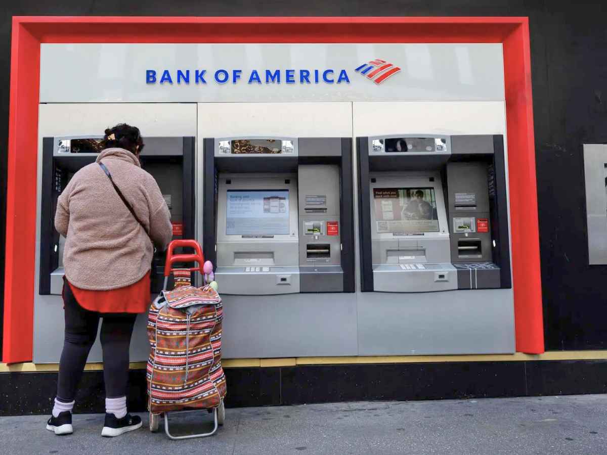 Customer using a Bank of America ATM outside a branch, symbolizing reliance on in-person banking as nationwide closures loom