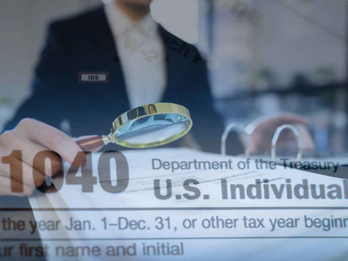 Magnifying glass over IRS Form 1040 highlighting May 2025 stimulus check refund schedule dates announced by the IRS