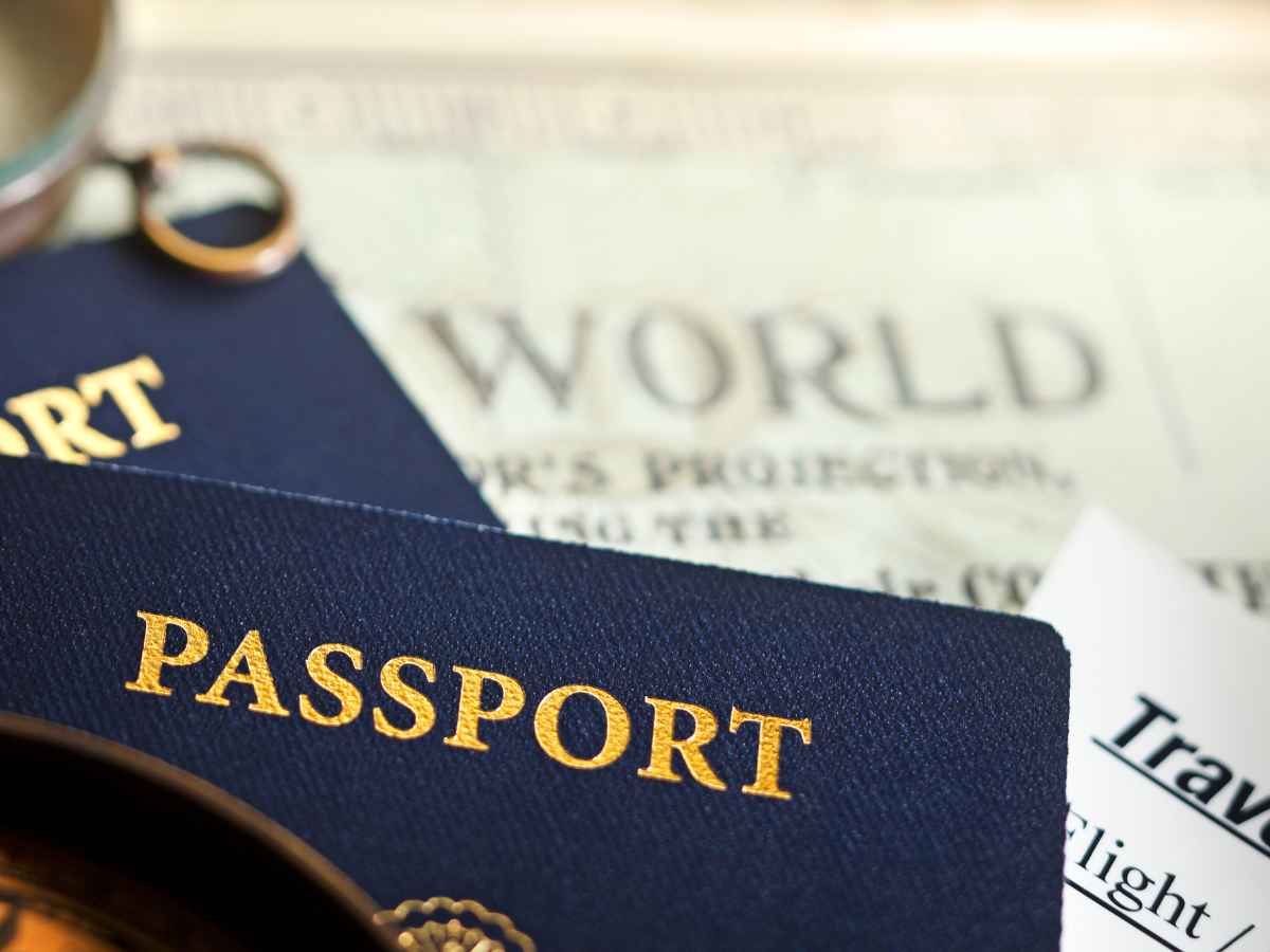 Close-up of U.S. passports beside a boarding pass on a world map, illustrating emergency passport requirements for last-minute international travel