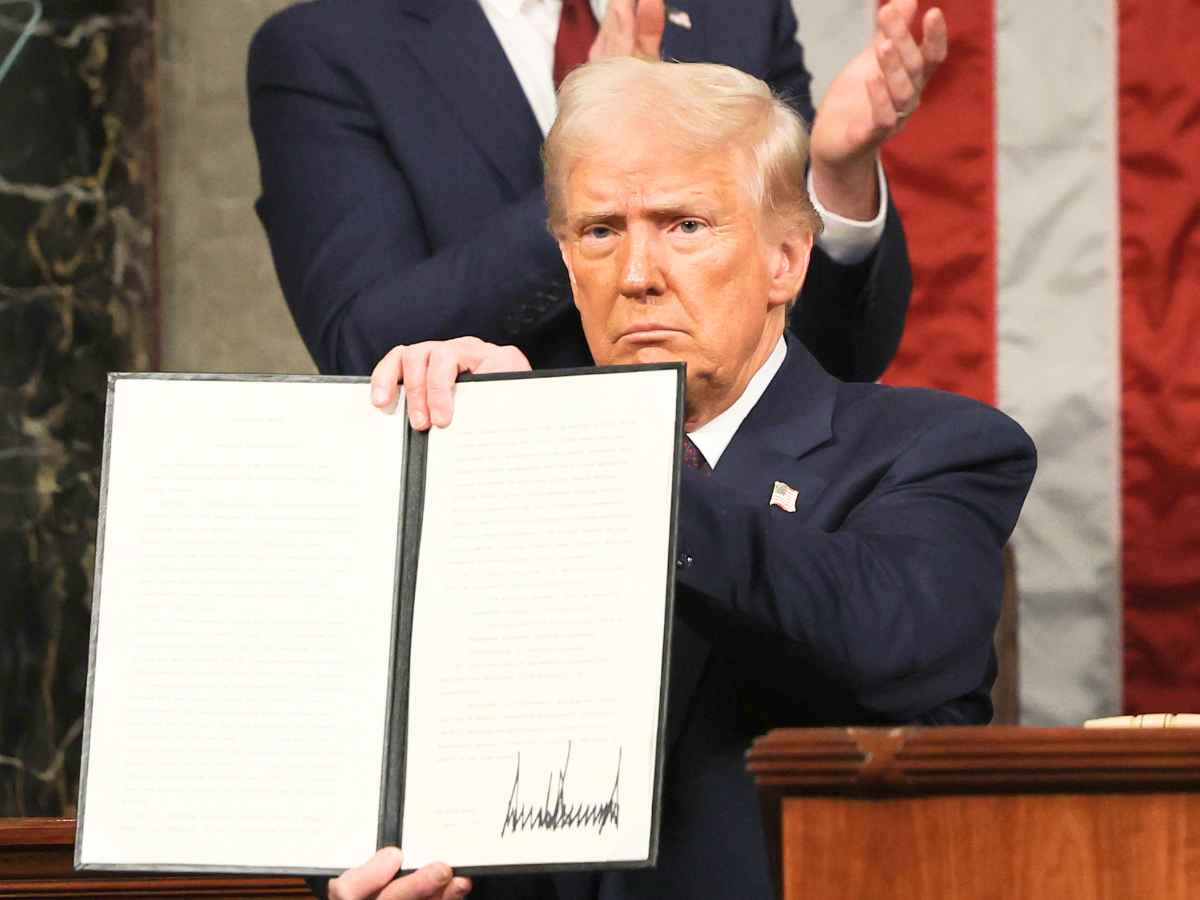 US official displays signed immigration order from the Trump administration imposing fines and jail for undocumented immigrants who skip registration