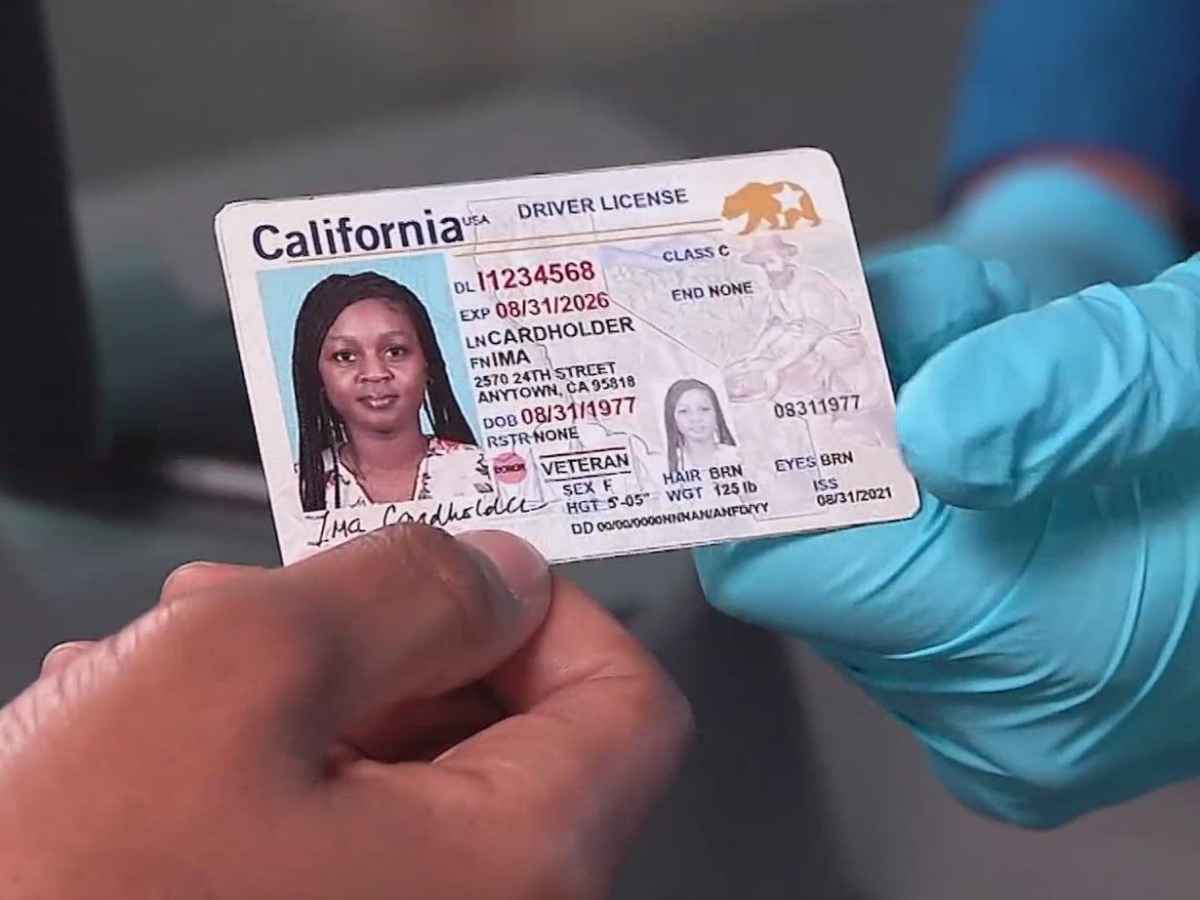 Close-up of a California driver's license being held, illustrating changes under SB 1100 employment law in 2024