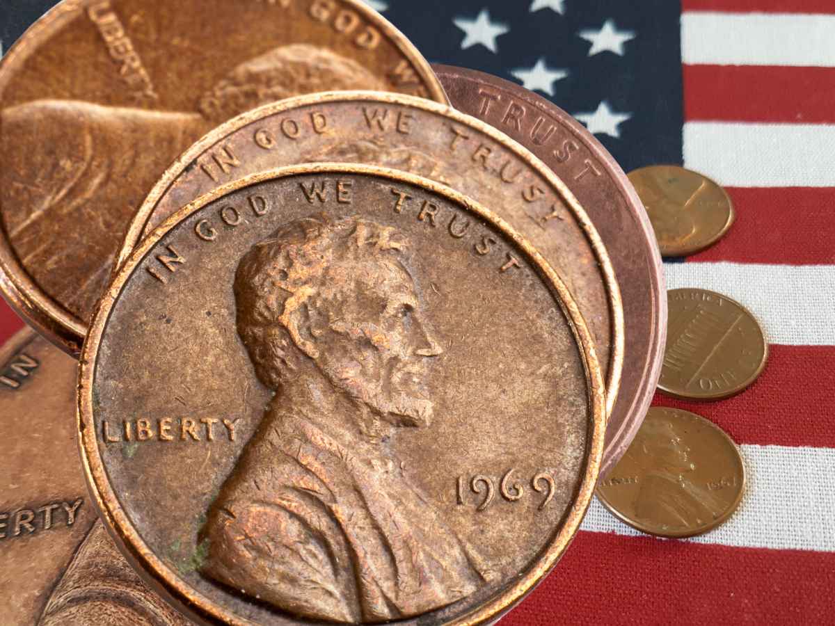 Close-up of stacked Lincoln wheat pennies on a U.S. flag; rare editions can sell for as much as $124 million