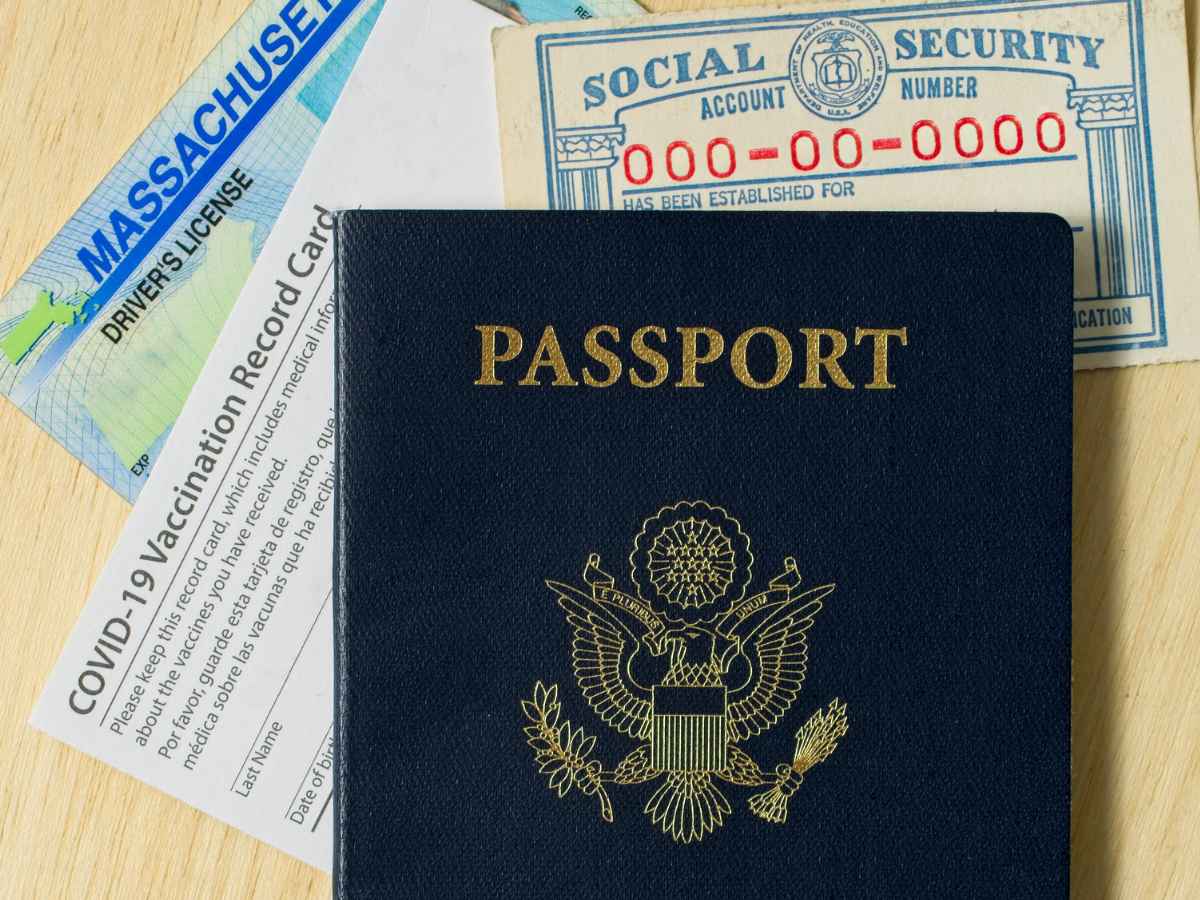 U.S. passport, Massachusetts driver’s license, Social Security card and COVID-19 vaccination record laid out as examples of Real ID documentation