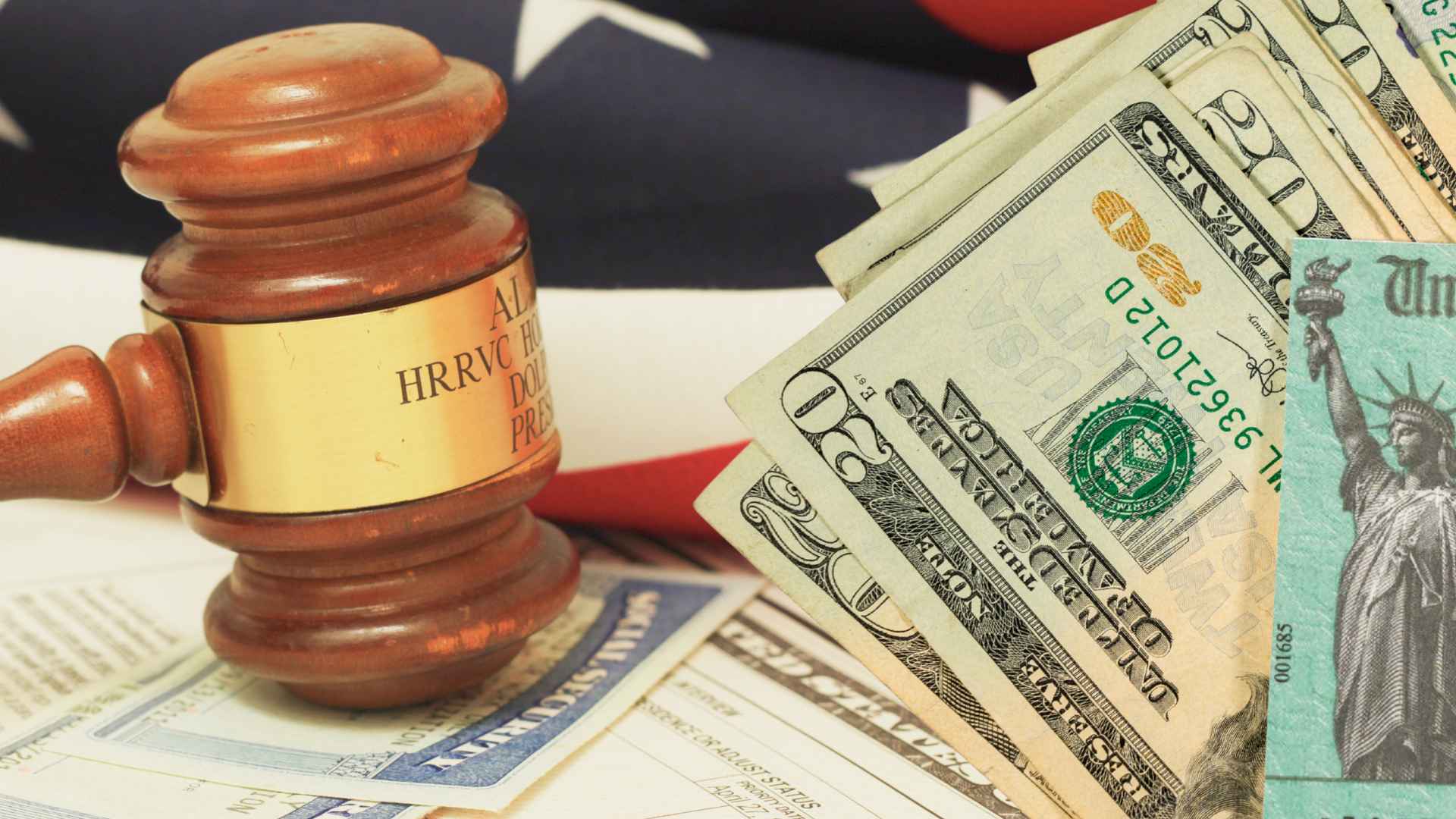 A wooden gavel resting on U.S. benefit forms alongside dollar bills and an American flag, illustrating the SSDI nine-month trial work period