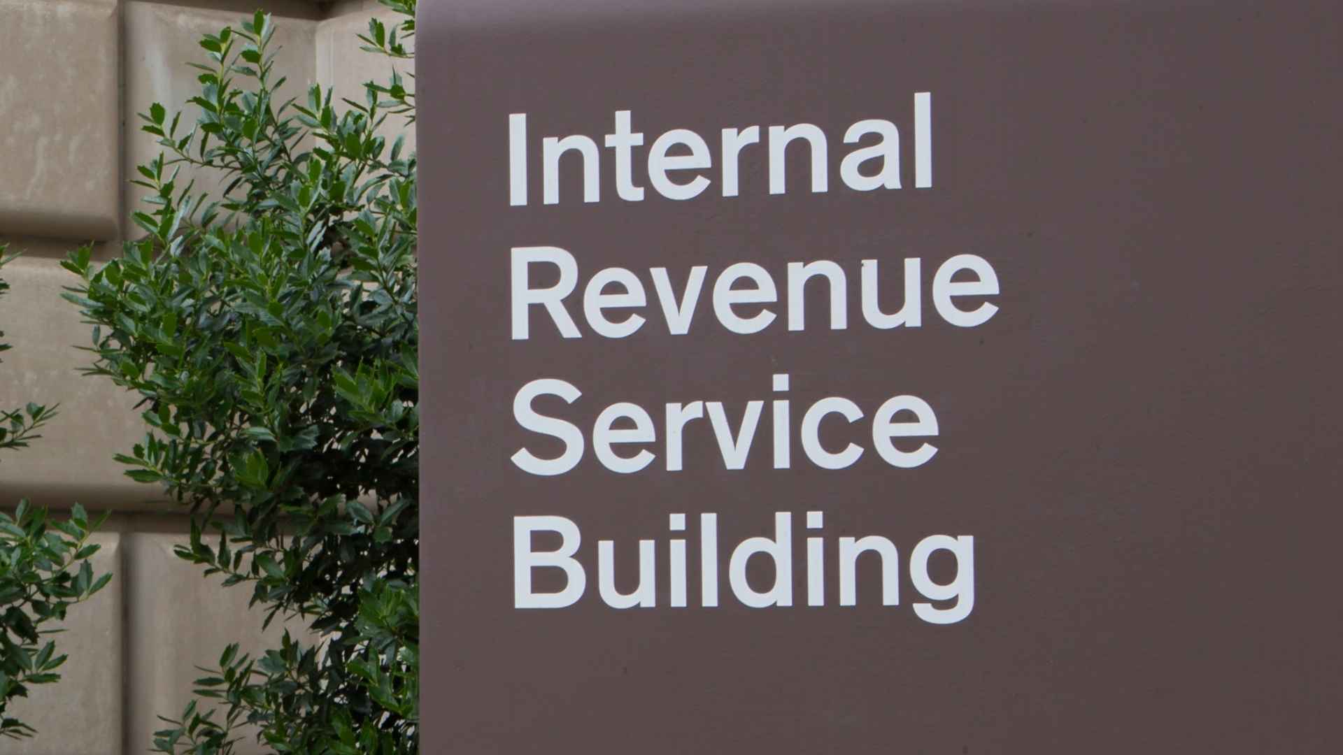 Sign reading “Internal Revenue Service Building” mounted on the exterior of the IRS headquarters