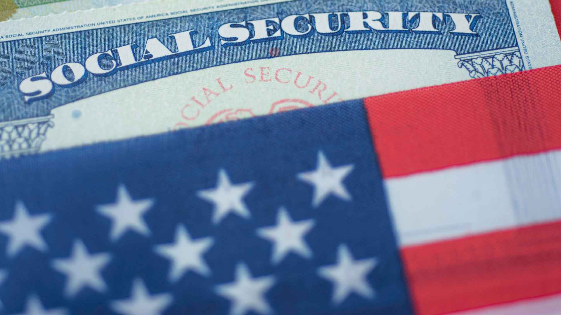 Social Security card behind U.S. flag symbolizing the SSA’s continuing disability review of SSDI benefits eligibility