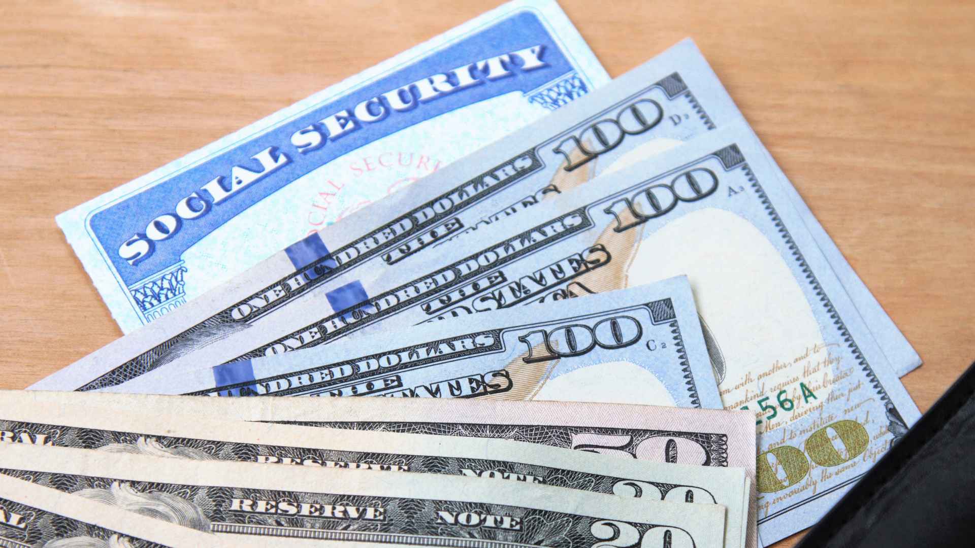 Social Security card with hundred-dollar bills highlighting June 2025 payment calendar for retirees, SSDI and SSI beneficiaries.