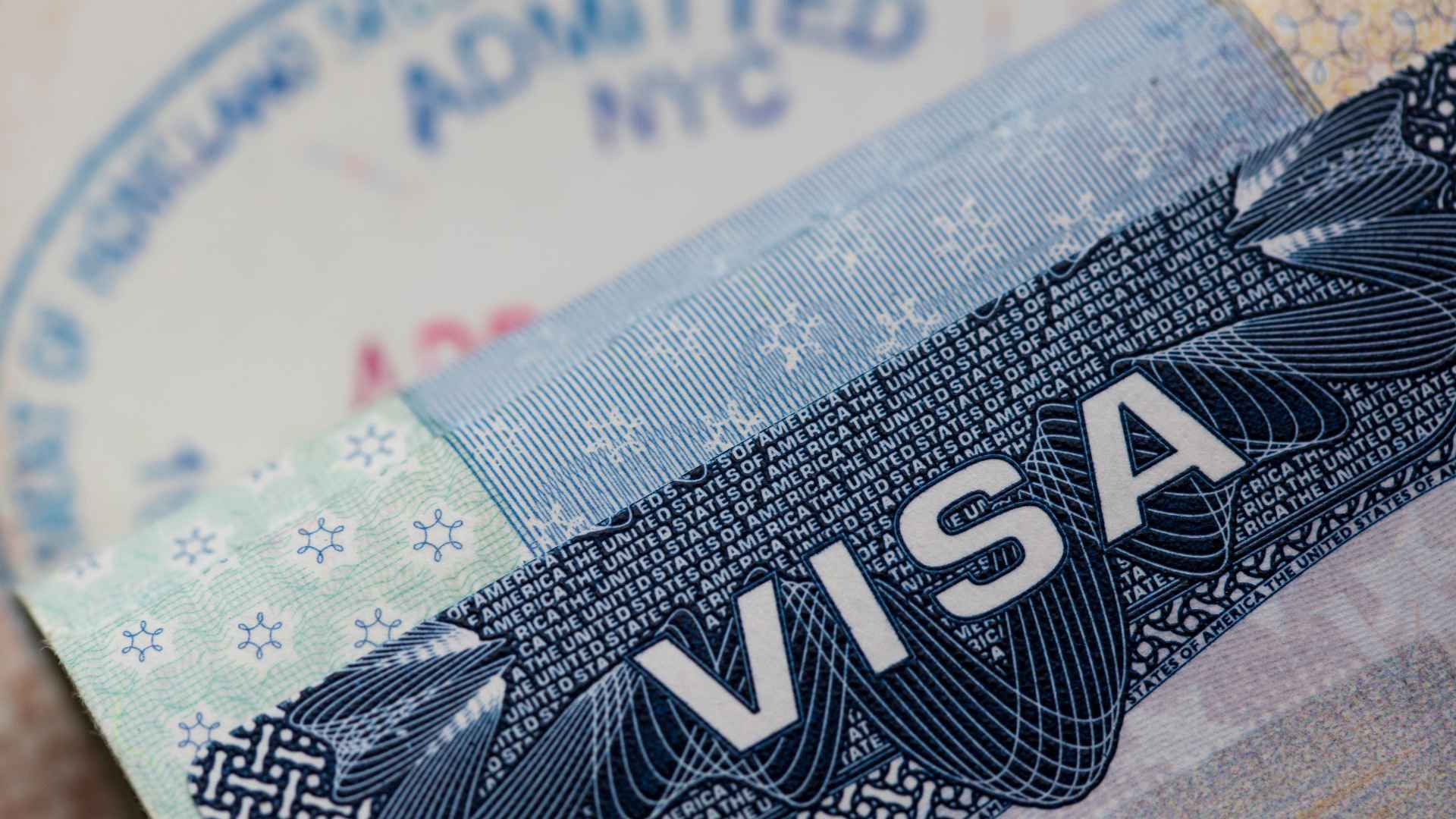 Close-up of a U.S. visa page highlighting security features, underscoring the May 2025 rule to match your DS-160 confirmation number with the interview booking