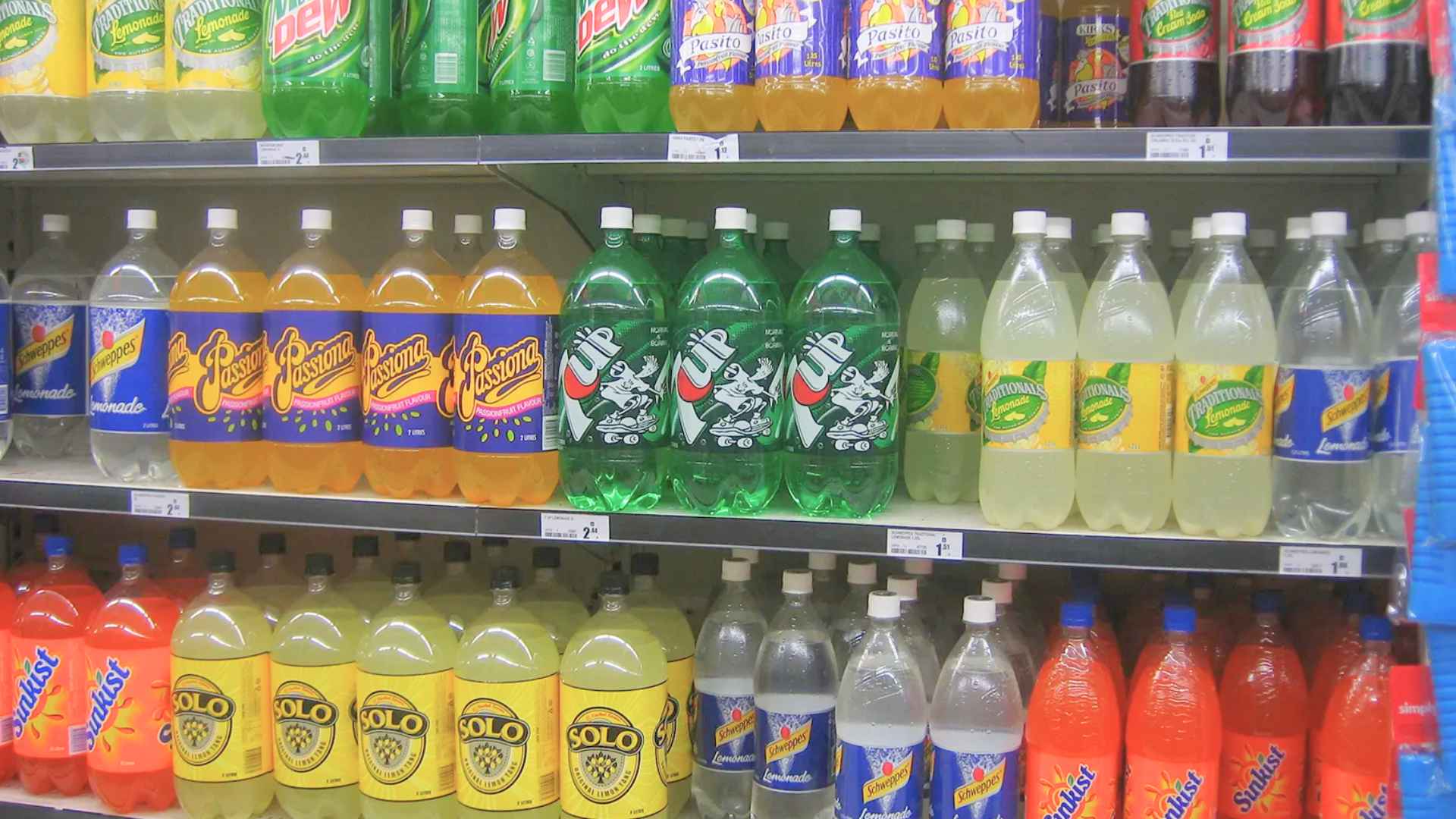 Grocery shelf stocked with soft-drink 2-liter bottles like 7UP, now off-limits to SNAP recipients after Nebraska ban.