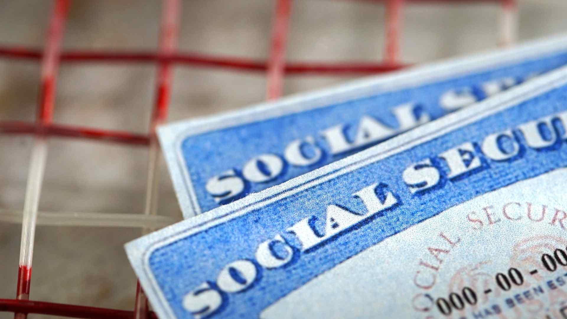 Close-up of two Social Security cards symbolizing benefit suspensions for 62-year-old retirees in spring 2025
