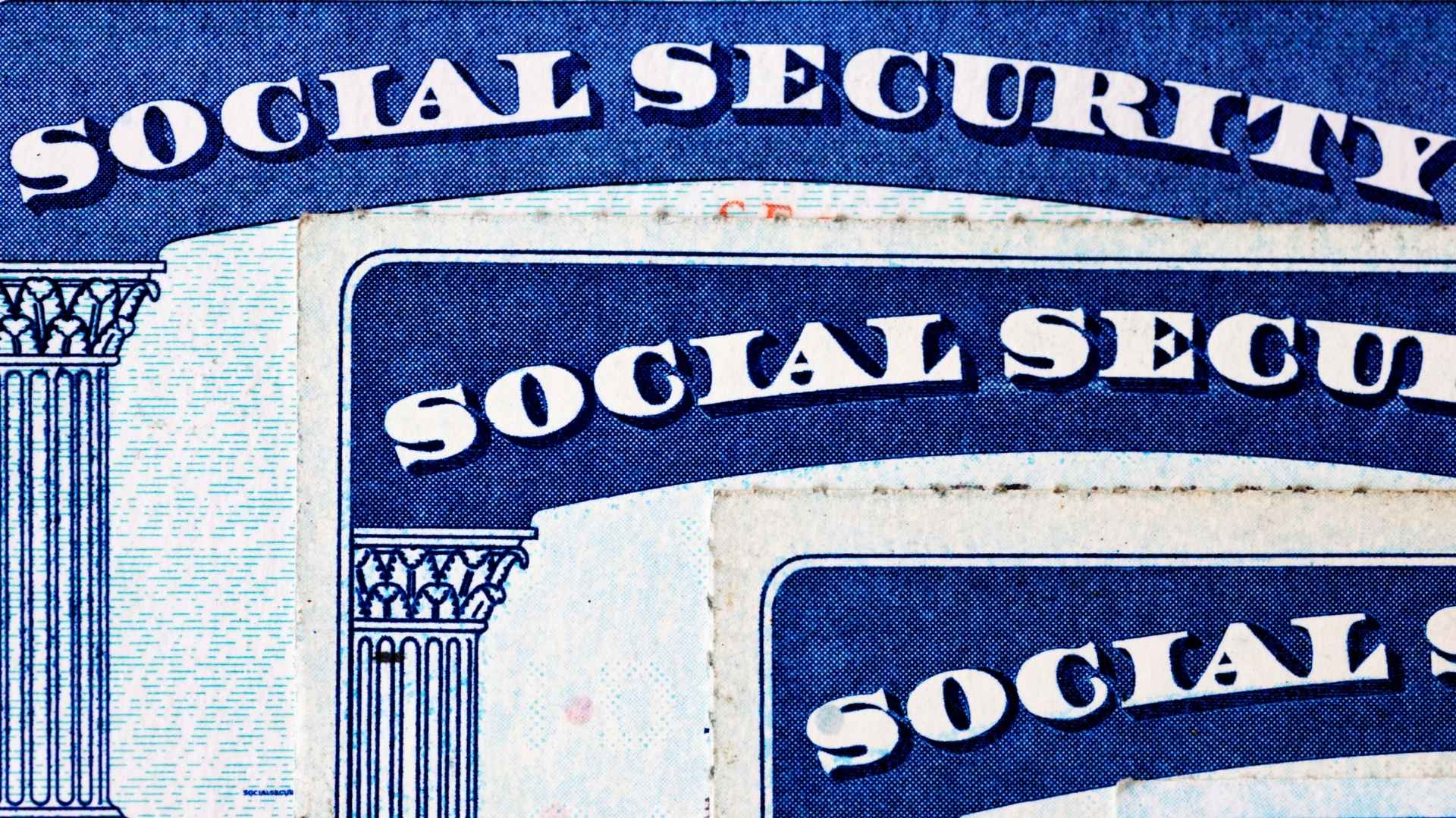 Close-up of overlapping Social Security cards, symbolizing benefit increases for retirees under the Social Security Fairness Act