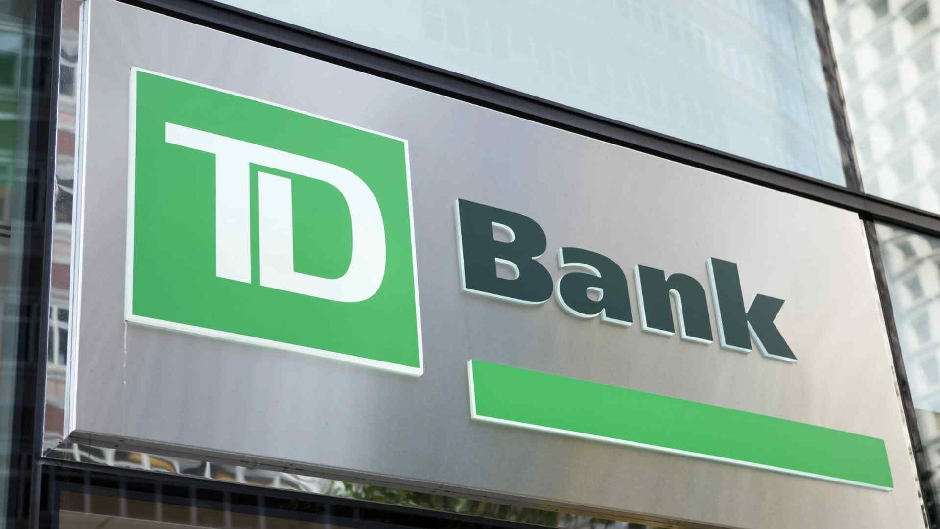 TD Bank branch sign on sleek glass facade ahead of 37 US branch closures in 2025