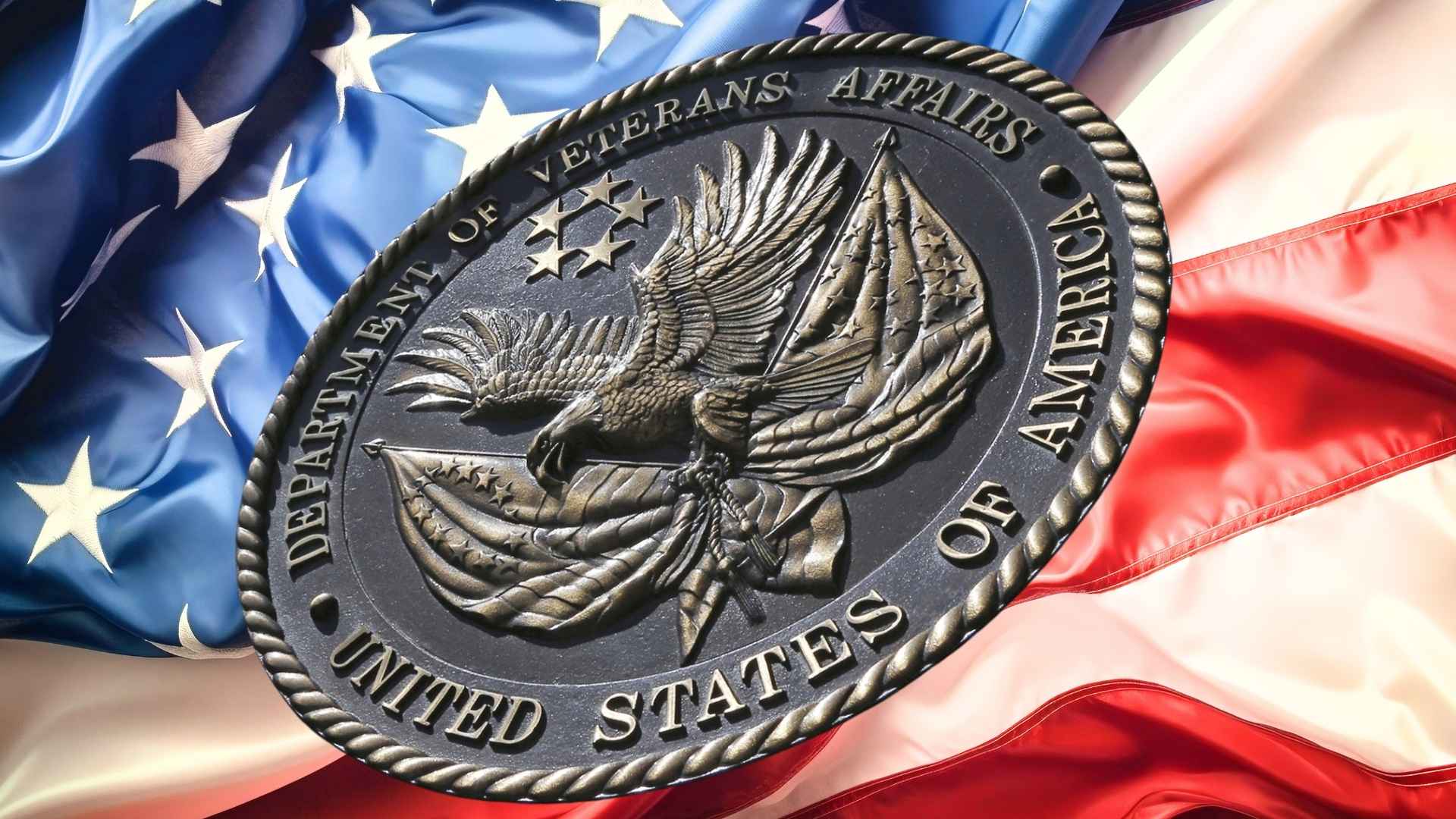 department of veterans affairs seal over american flag symbolizing va survivor benefits overhaul