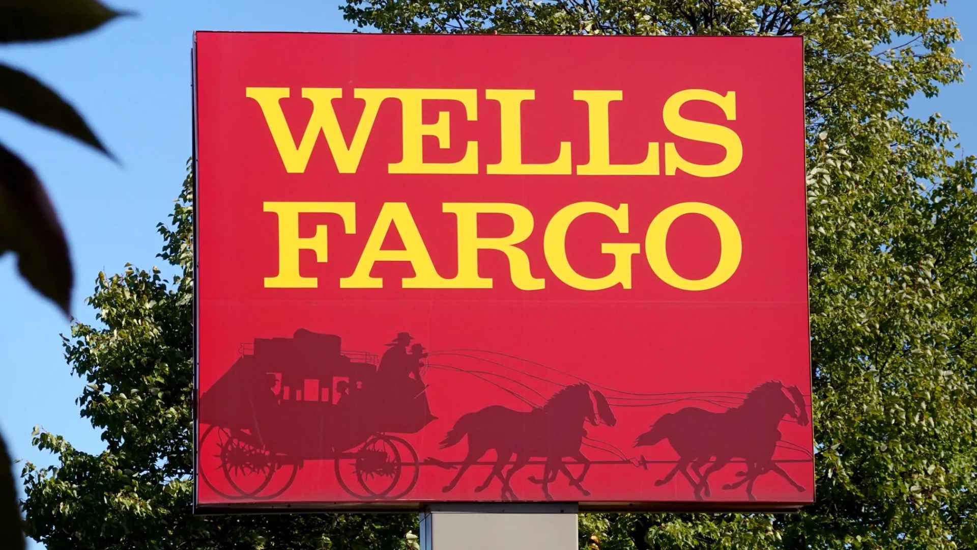 Wells Fargo red sign with large yellow lettering and stagecoach emblem, illustrating the bank amid inactive-account closure news.