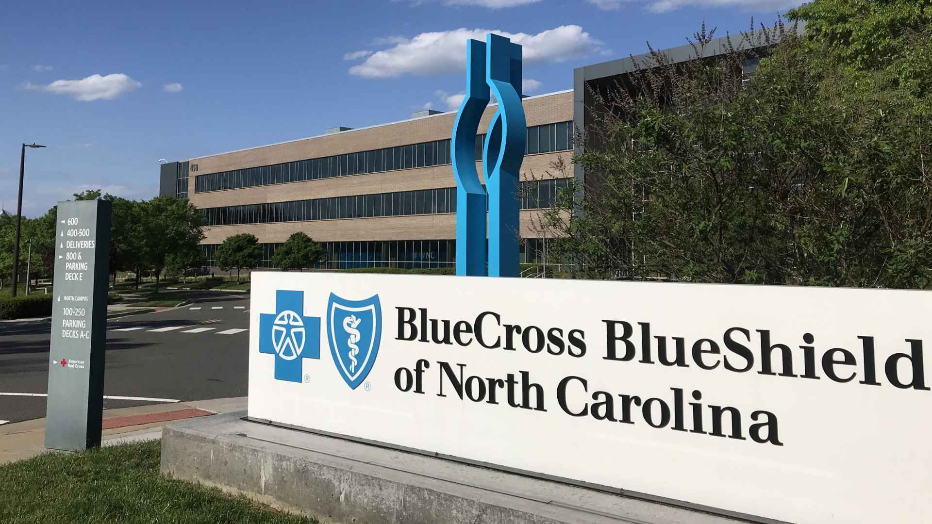 Blue Cross Blue Shield of North Carolina sign outside the insurer’s headquarters, symbolizing the ongoing $333 settlement payments to beneficiaries.