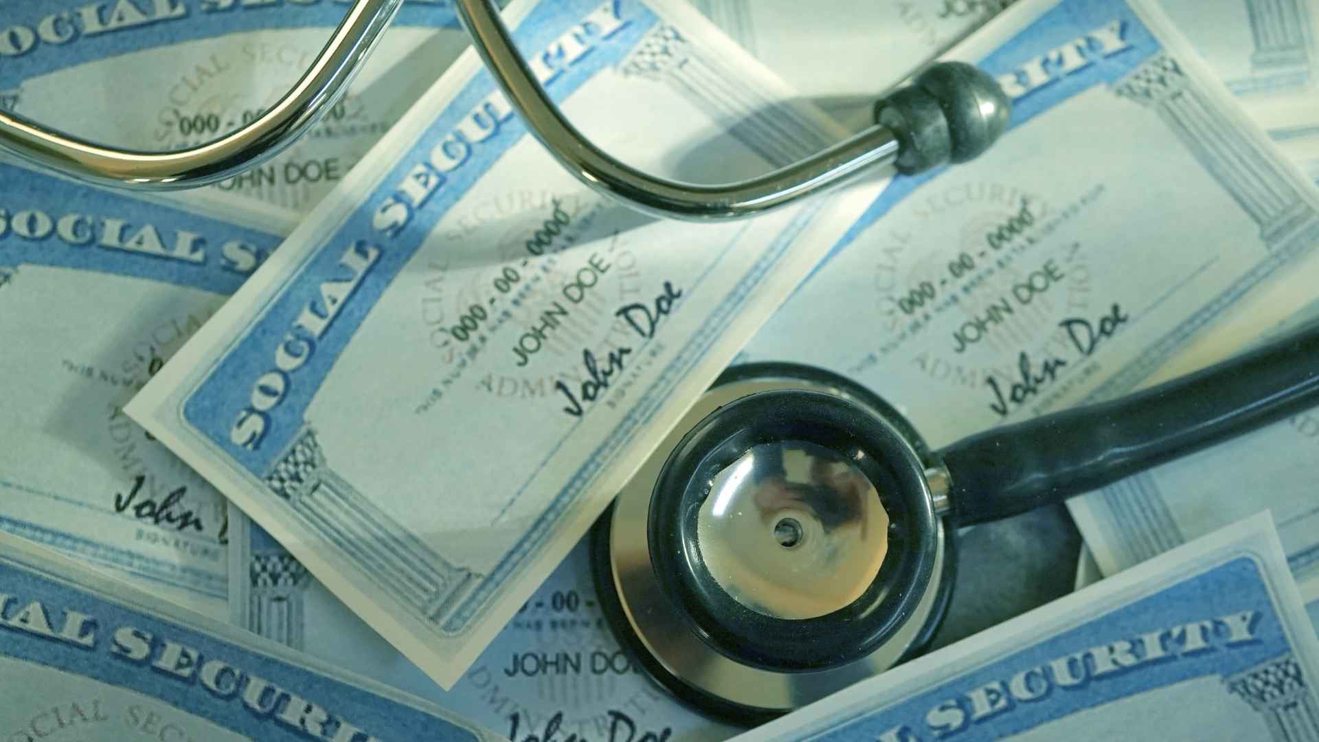 Stethoscope atop Social Security cards illustrating SSDI medical review deadlines, required forms and red-flag issues risking benefits.