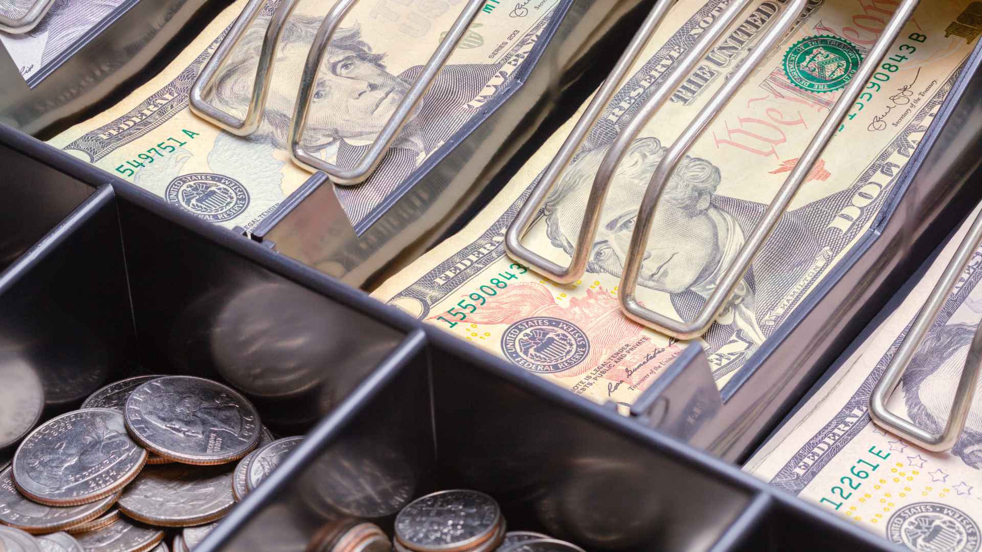 Close-up of gas station cash register with quarters and bills, where rare $3.2 million coin was discovered