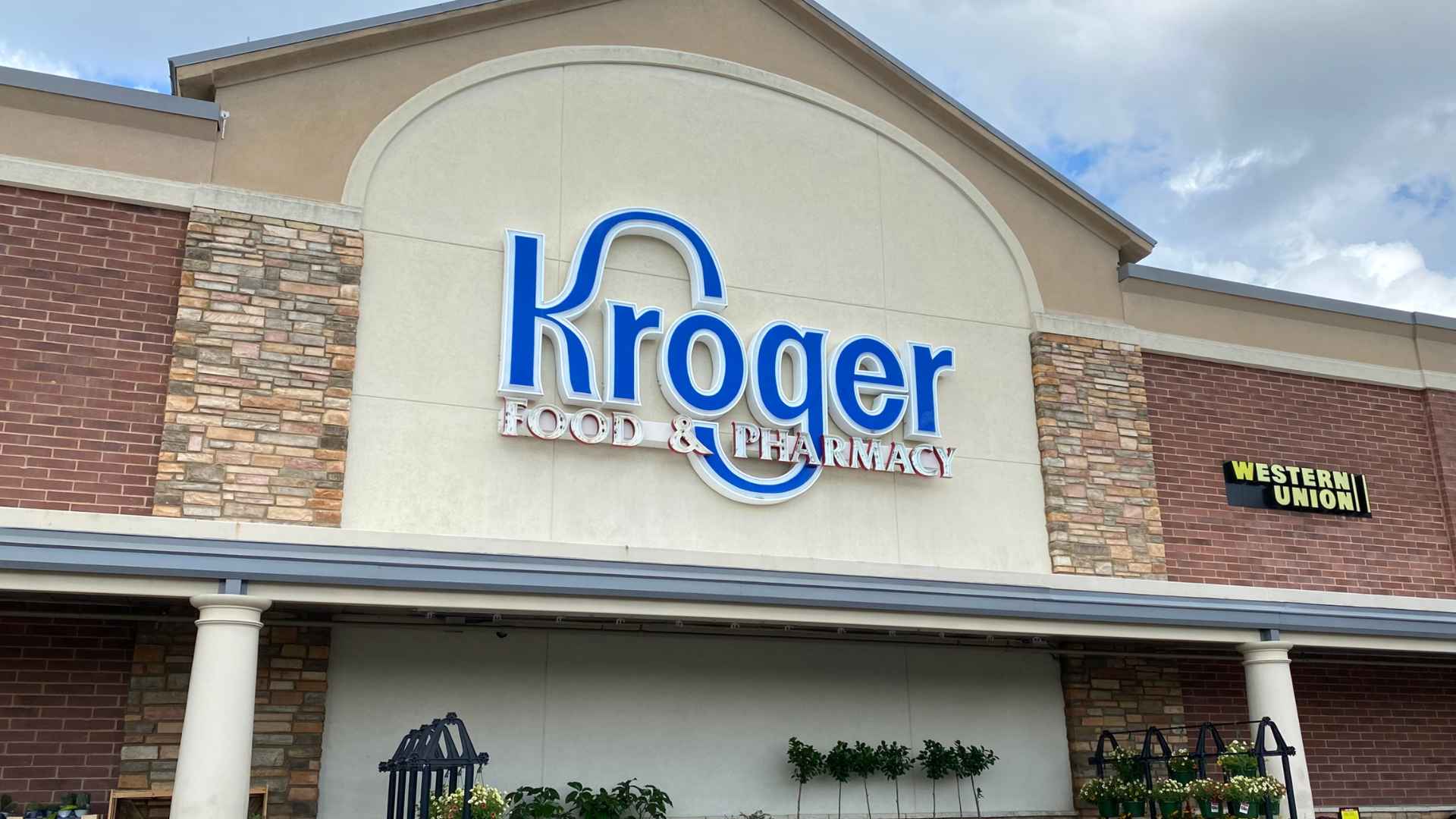 Kroger Food & Pharmacy storefront with prominent blue logo on brick-and-stone facade, illustrating the chain’s planned 60-store closure.