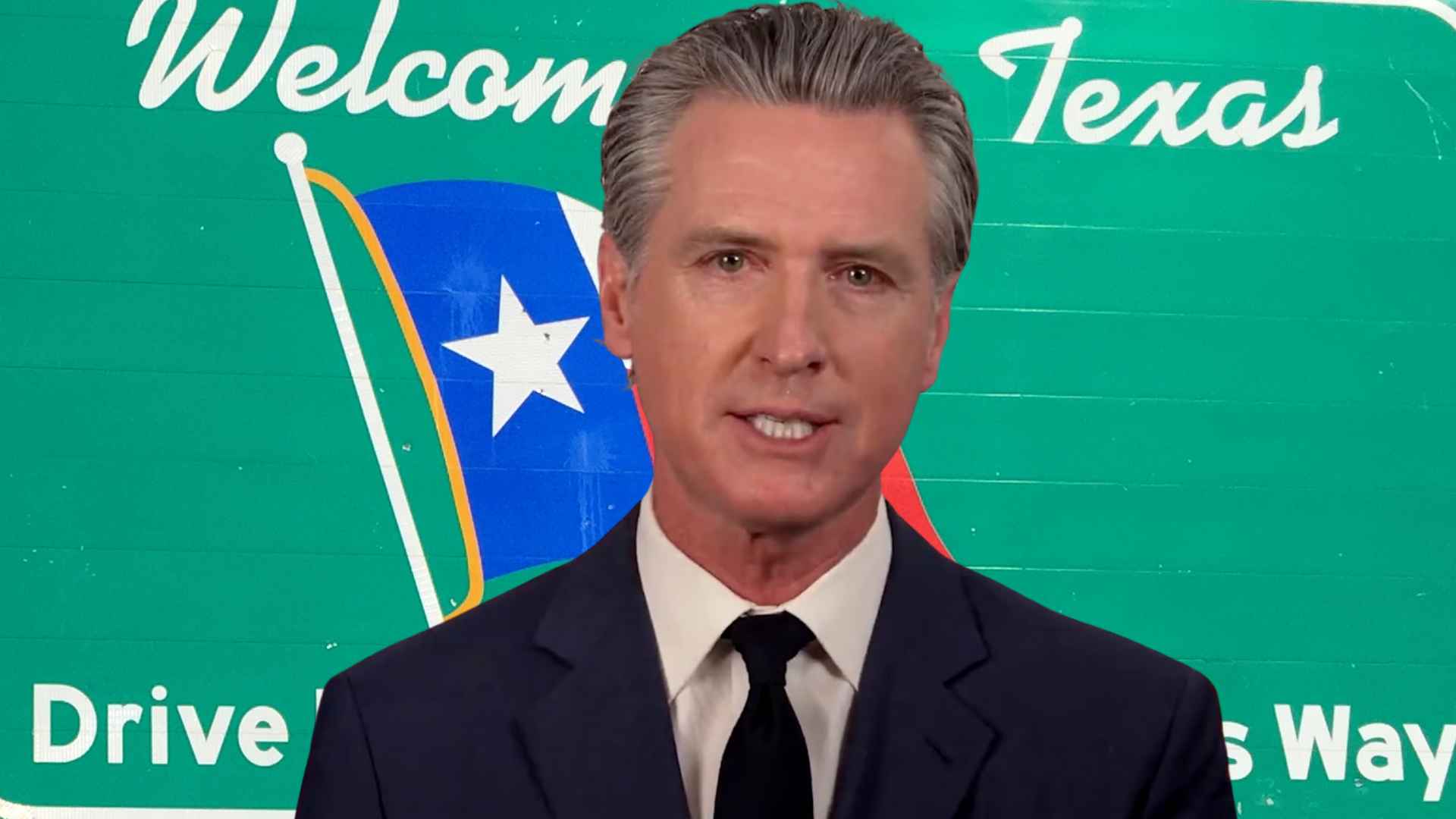 Gavin Newsom in front of Texas welcome sign during policy discussion