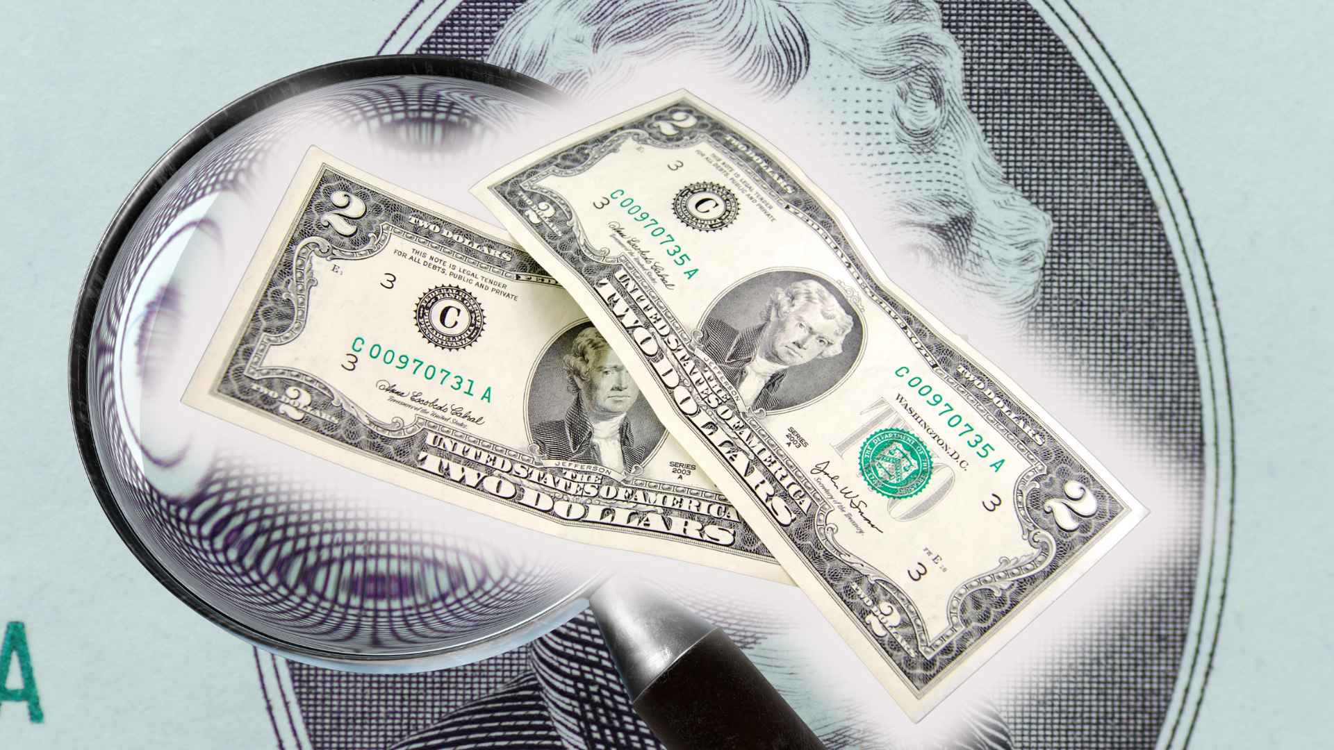 Rare $2 bills with unique serial numbers under magnifying glass