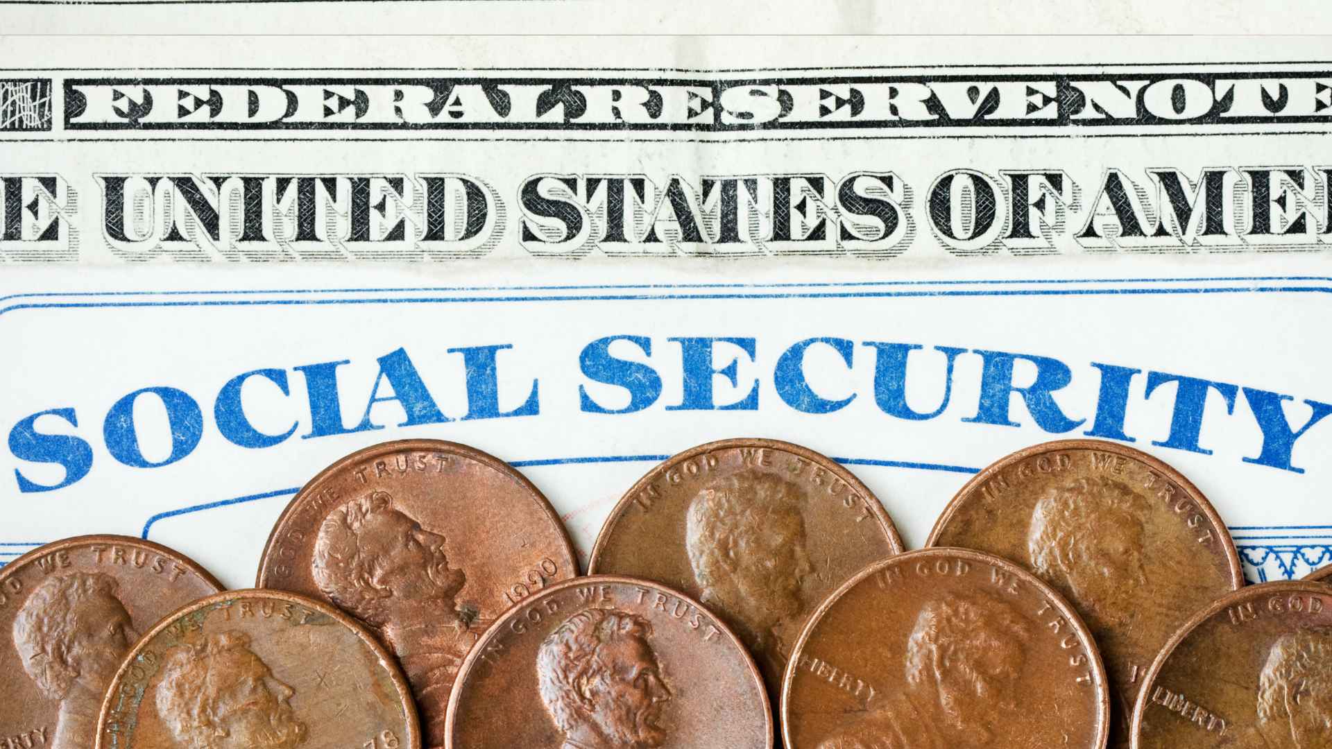 Close-up of a Social Security card, several pennies, and part of a U.S. dollar bill—visualizing the confirmed $5,108 maximum retirement benefit for qualified retirees.