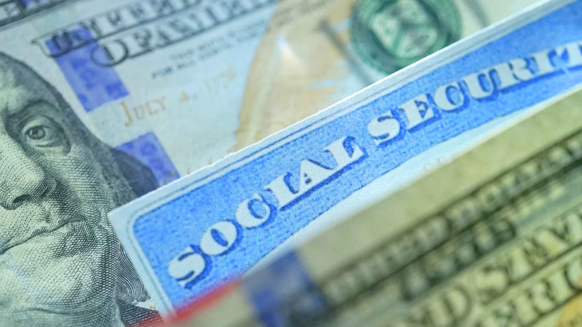 Close-up of Social Security card atop hundred-dollar bill highlighting new SSA in-person identity verification rule
