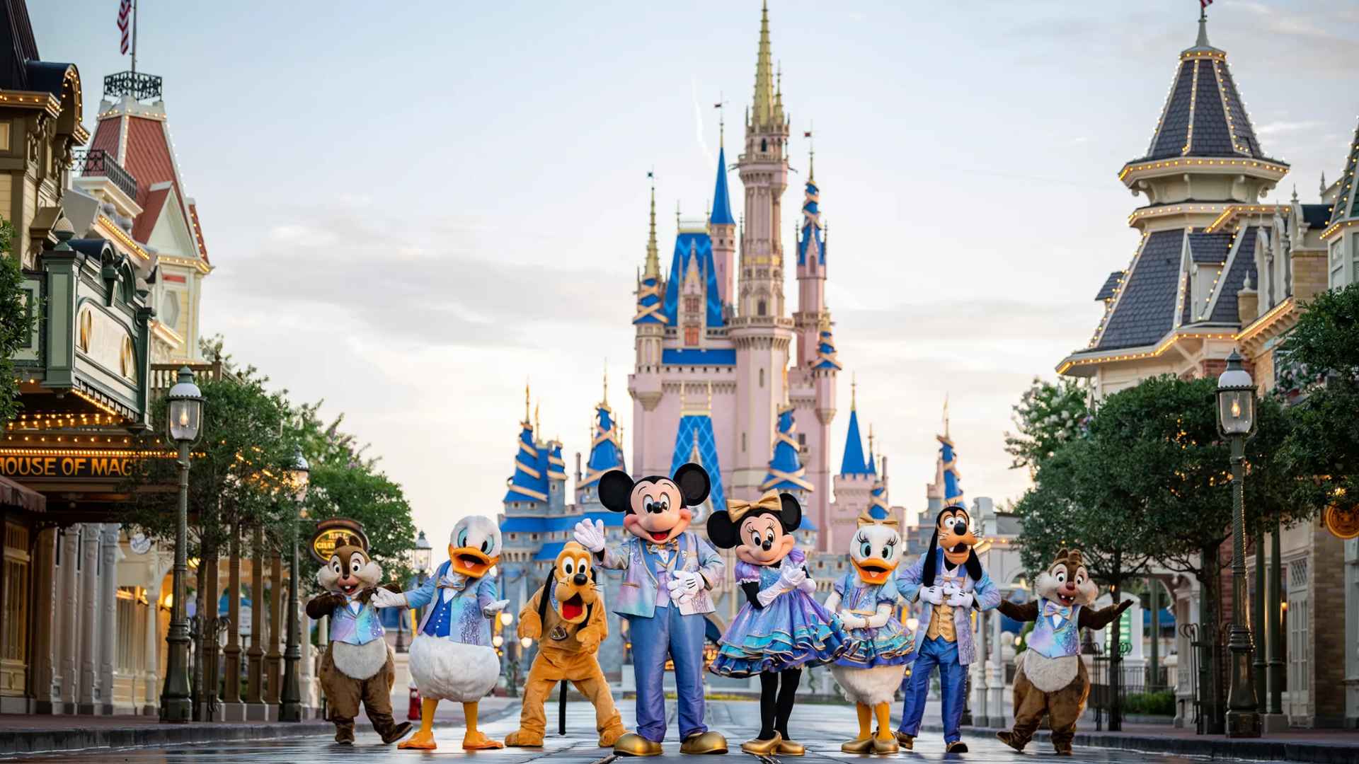 Walt Disney World characters posing on Main Street with Cinderella Castle in the background before attraction closures