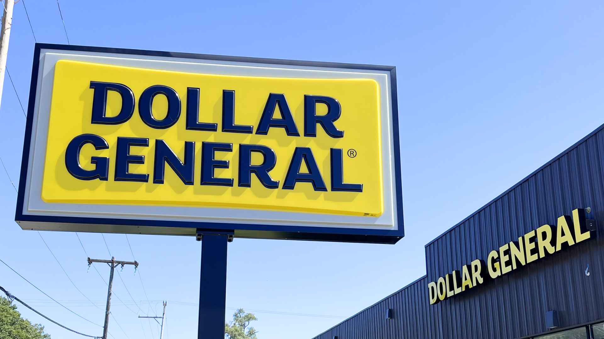 Dollar General storefront and bright yellow logo sign during the nationwide “7 Days of Savings” summer discount campaign.
