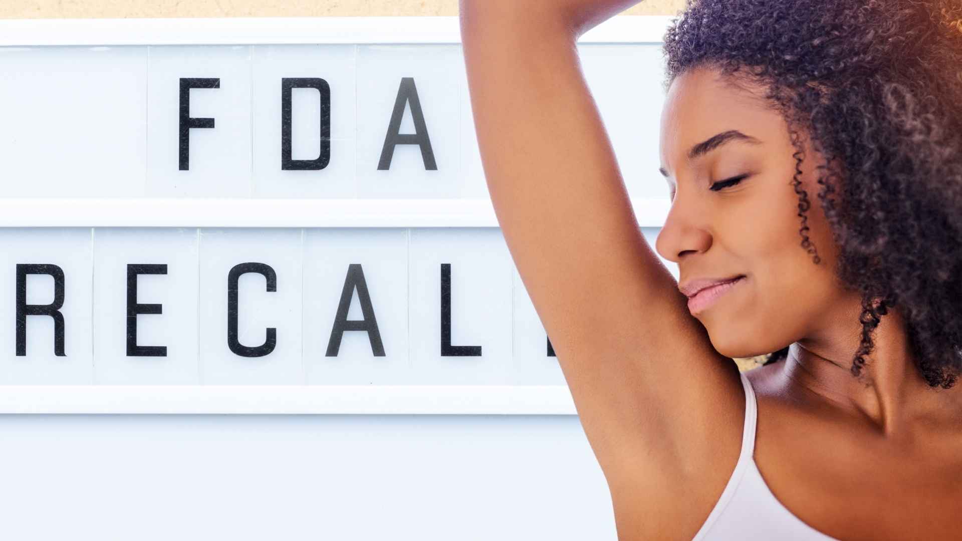 Woman using deodorant next to FDA recall sign for Power Stick deodorants at Walmart and Amazon