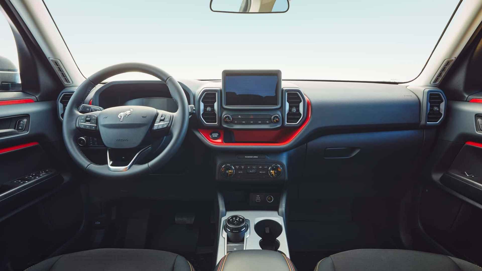Interior dashboard of Ford Bronco Sport SUV highlighting steering wheel, infotainment screen, and control panel.