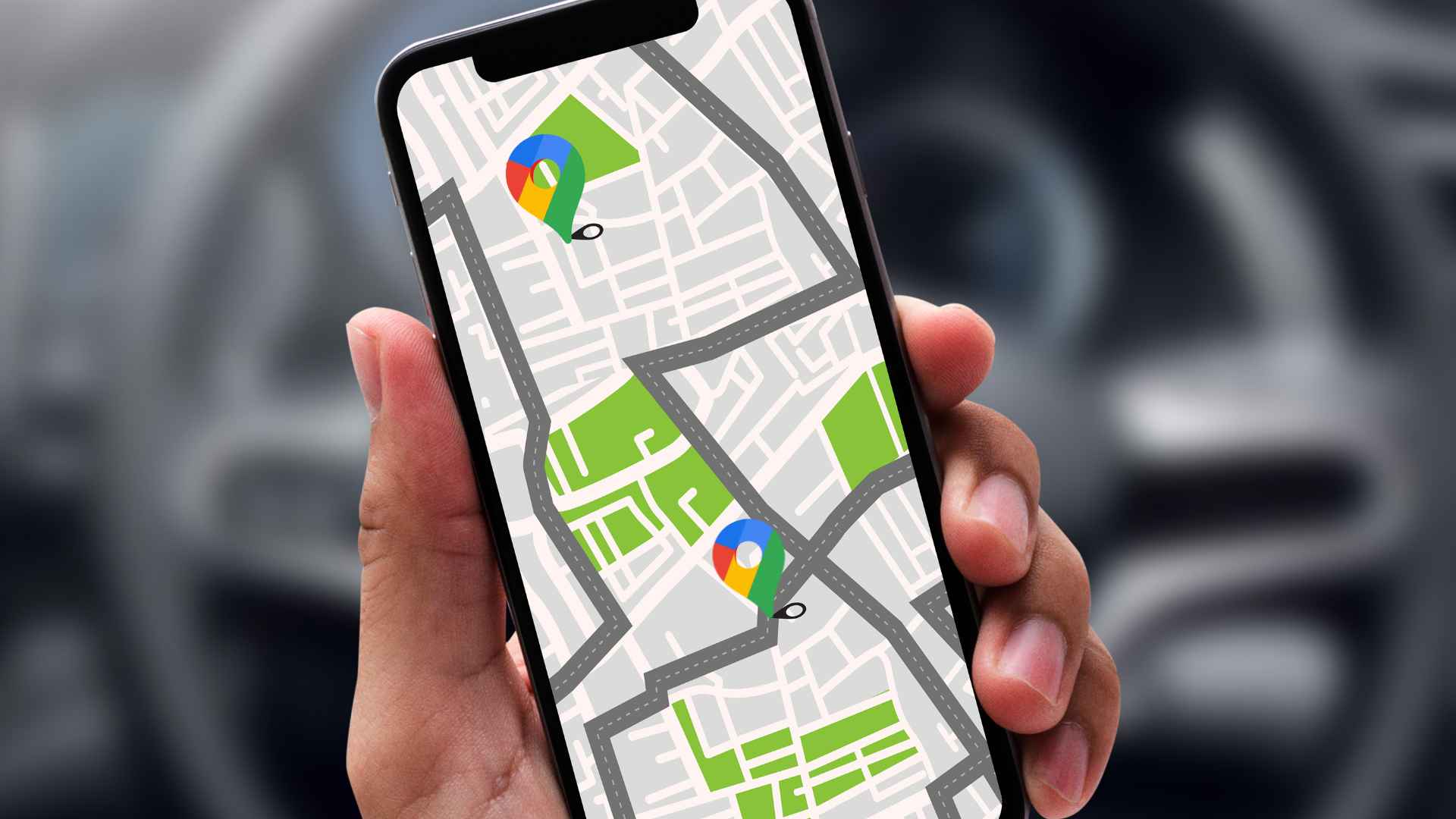Google maps on smartphone showing navigation routes with map pins inside a car