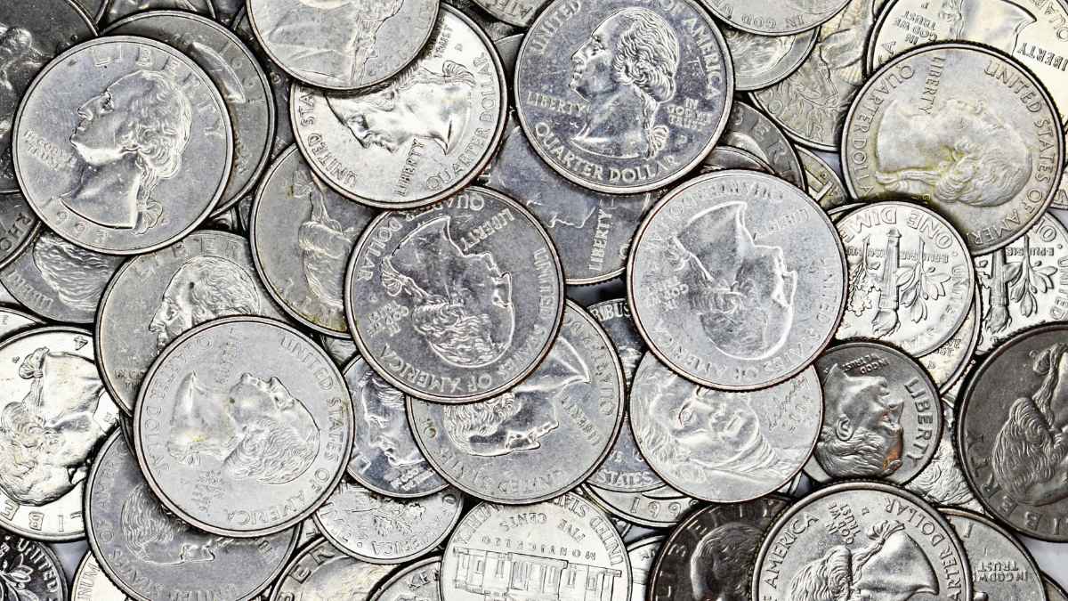 Close-up view of various U.S. quarters, including a 1976 Bicentennial quarter among other coins