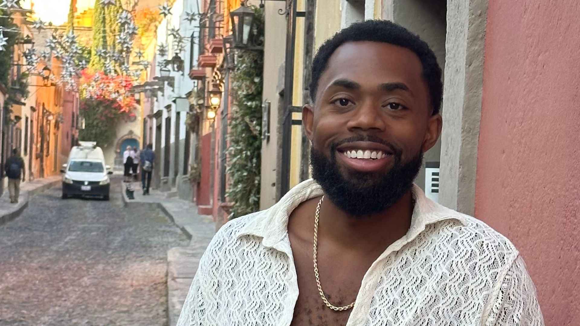 Smiling lawyer standing on a colorful street in Mexico City where he runs his $40K-per-month remote business
