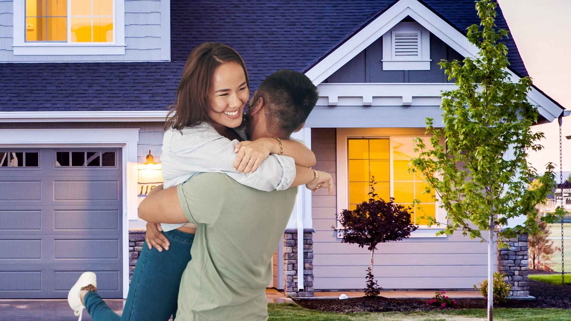Happy young couple celebrating owning their home outright in the U.S. housing market.