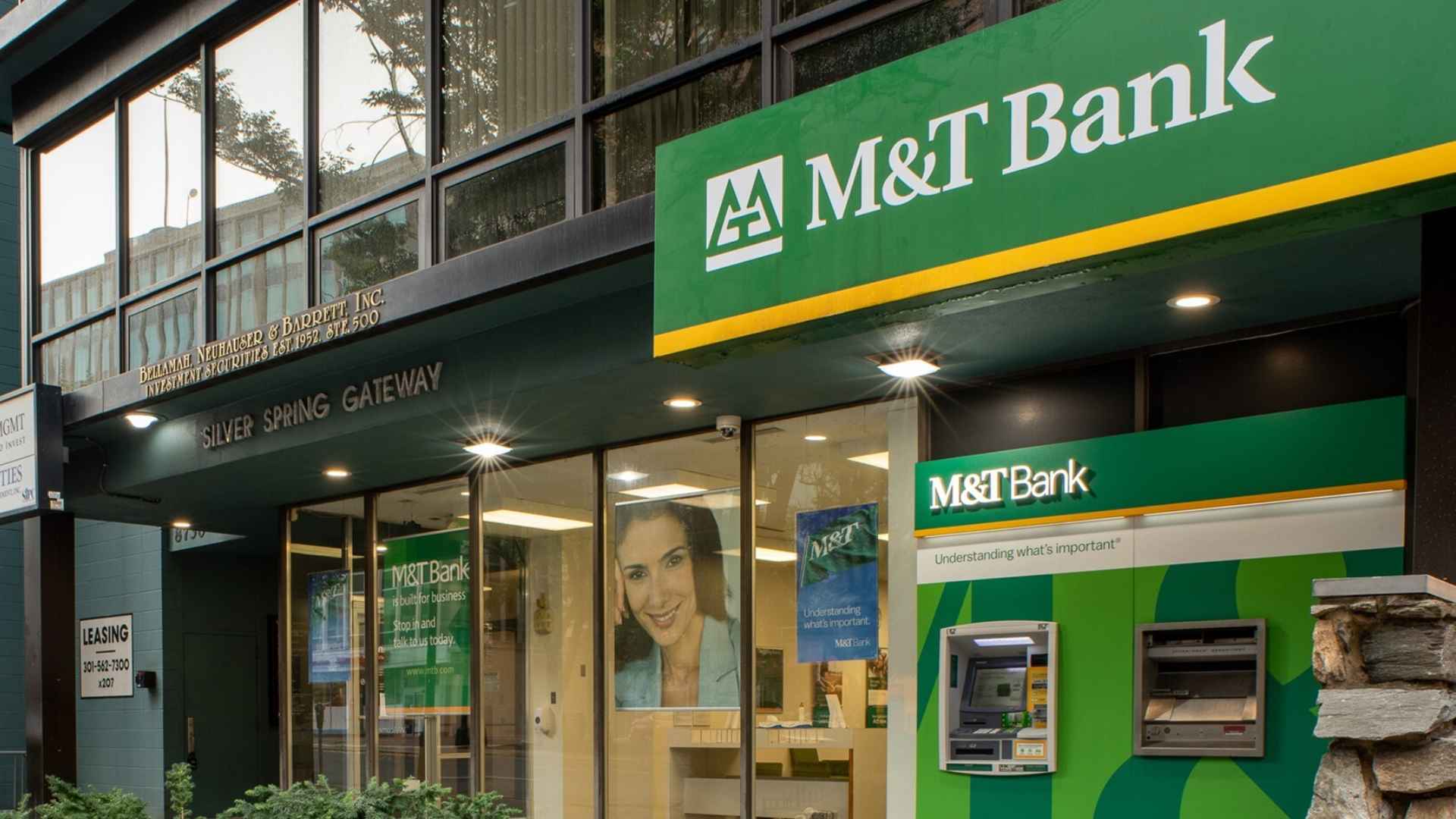 Exterior view of an M&T Bank branch showing ATM machines and logo, offering a $200 cash bonus for new checking accounts opened by July 31.
