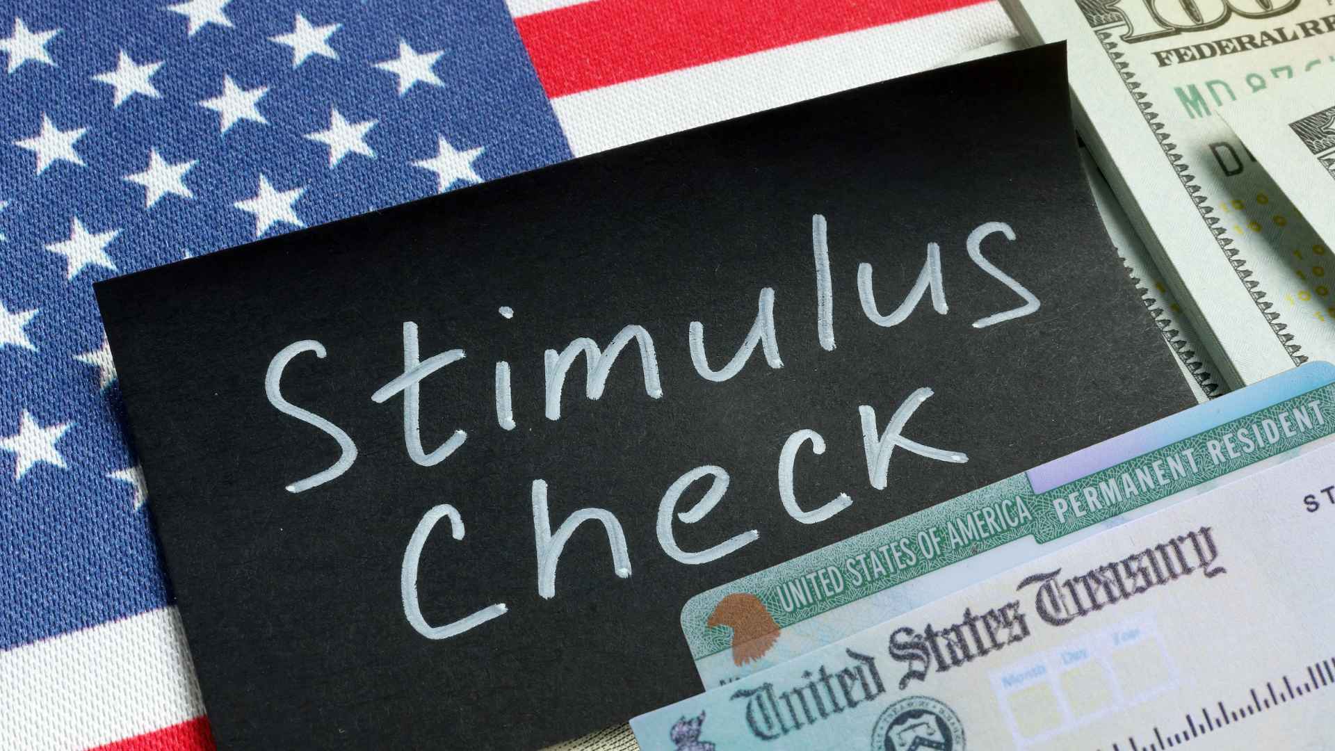 Stimulus Check note on U.S. flag beside Treasury check and cash, illustrating 2025 state relief payments