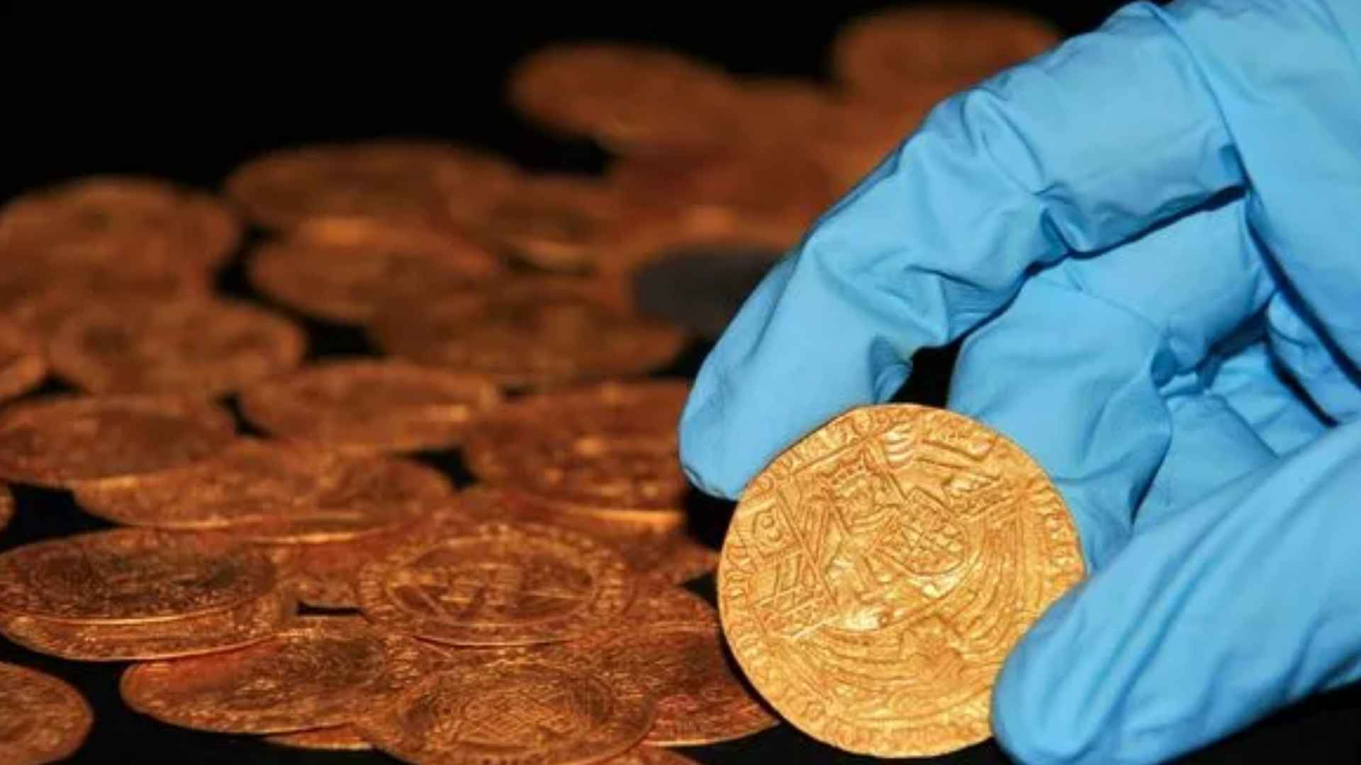 Hand holding rare gold coin pendant discovered near Thaxted, evidence of early medieval Essex elite society