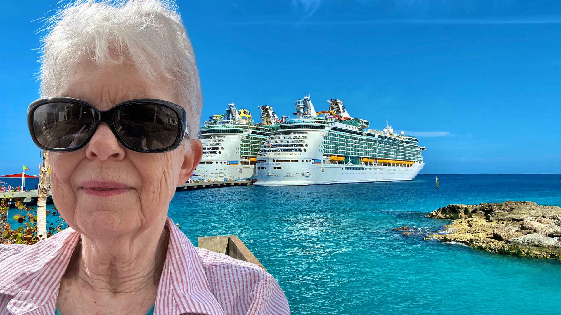 retired woman wearing sunglasses standing by cruise ship where she plans to live for 15 years