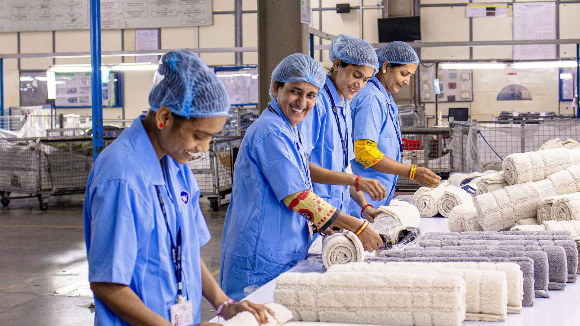 Group of smiling workers in a factory representing beneficiaries preparing for 2025 Social Security payment changes