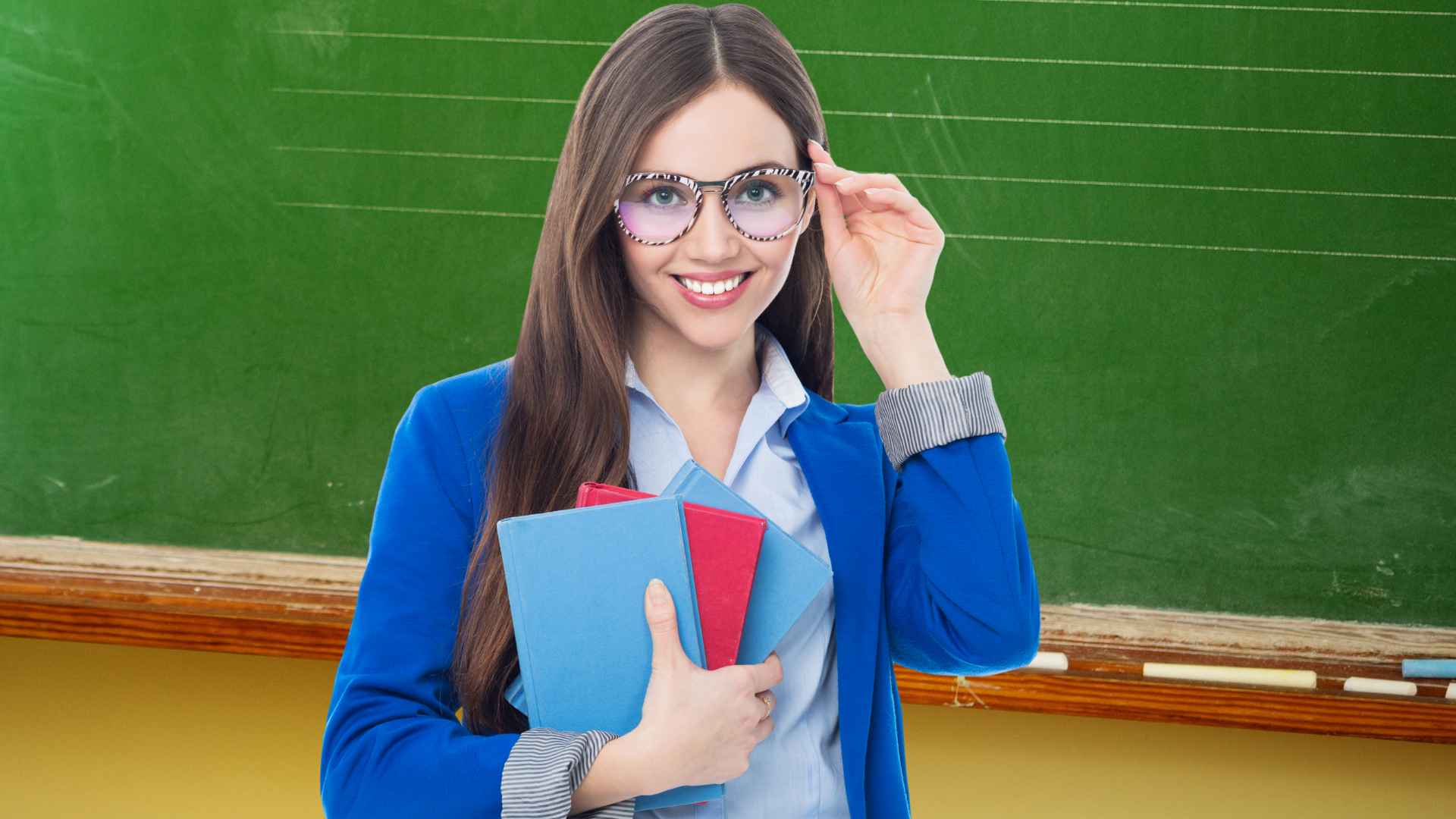 Smiling teacher holding books in front of classroom chalkboard, representing highest-paid teachers in US city