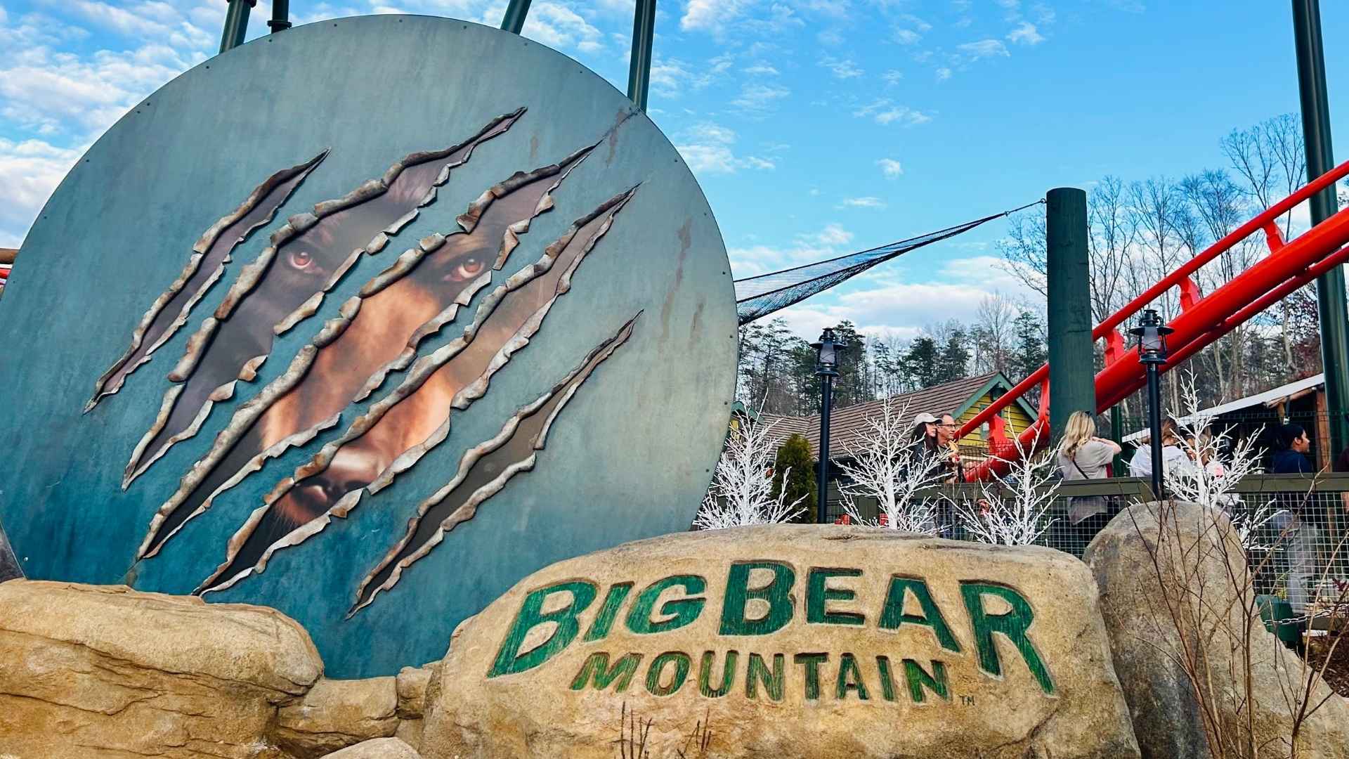 Big Bear Mountain roller coaster at Dollywood theme park in Pigeon Forge, Tennessee, with claw-marked bear mural and red track