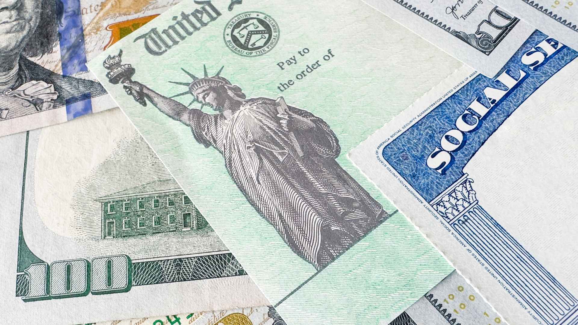 Close up of Social Security card with U.S. Treasury check and cash representing benefit payments