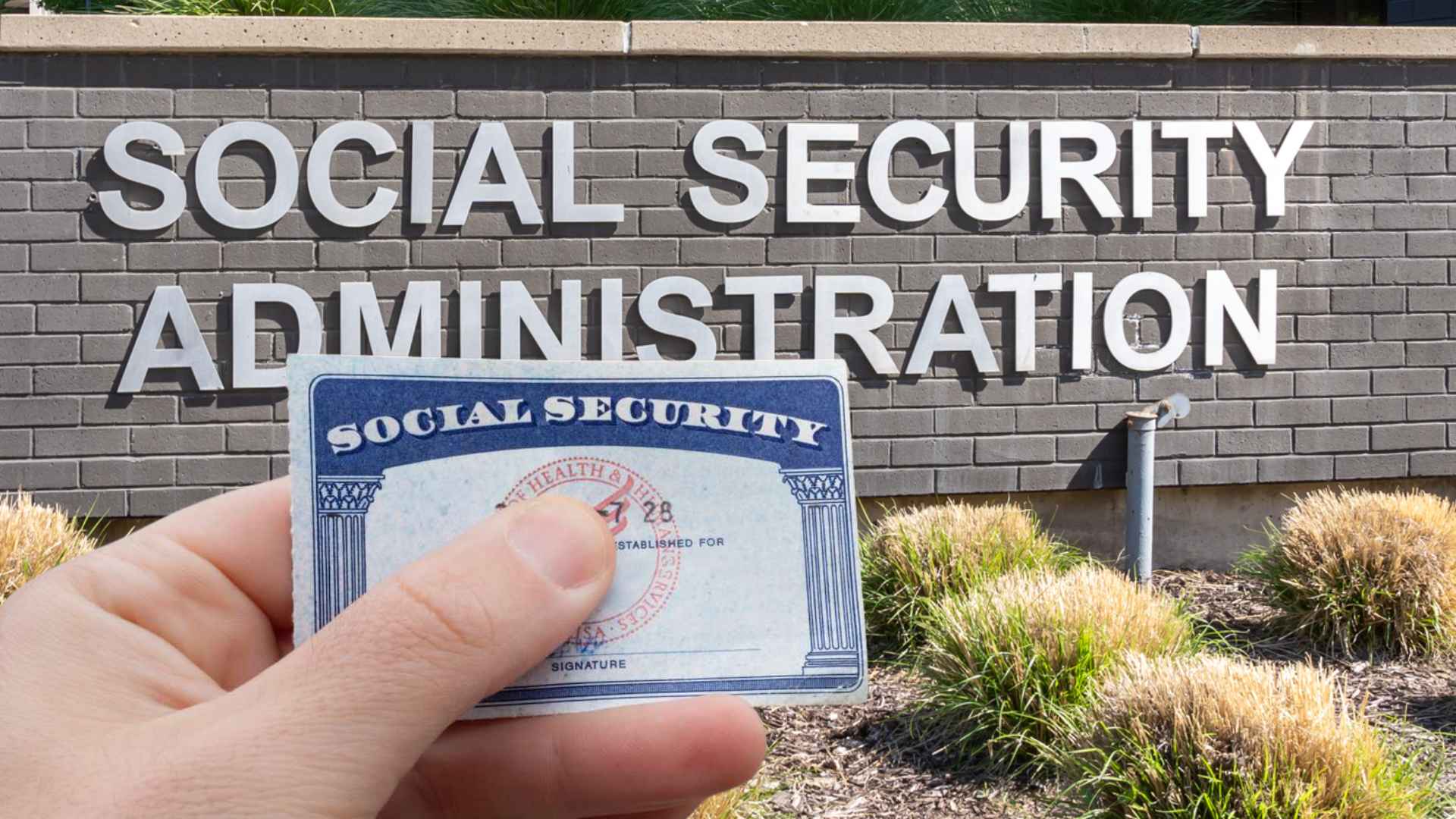 Person holding a Social Security card in front of a Social Security Administration office sign.