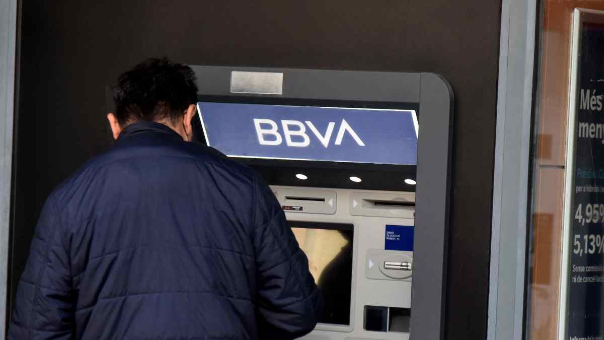 Hombre utilizando un cajero automático de BBVA tras el despido de un trabajador por conceder un préstamo indebido